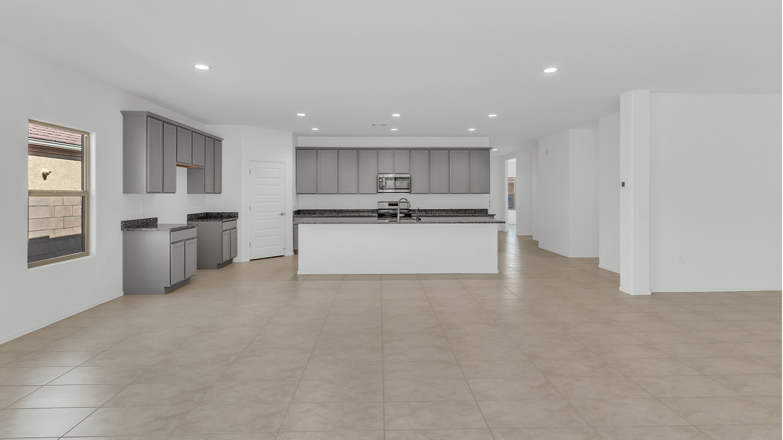 Welcome to The Citrine, a spacious single-story new home located in the tranquil Cholla Ridge neighborhood of Saguaro Bloom. With 2,577 square feet of well-planned living space, this home offers four bedrooms, three bathrooms, and a dedicated study, making it ideal for families who value both space and convenience.  As you enter through the inviting covered porch, you’re greeted by a bright and airy entryway that flows into the heart of the home. The expansive great room, dining area, and kitchen are thoughtfully connected, creating an ideal space for entertaining or simply enjoying time with family. The kitchen is a chef's dream, featuring a large island, granite countertops, and Shaker-style cabinetry in double espresso. A spacious pantry and modern stainless steel gas appliances ensure that this kitchen is both functional and stylish.  The Citrine’s layout includes a generously sized primary bedroom, carefully positioned for privacy at the rear of the home. This room features a large walk-in closet and an en-suite bathroom with dual executive-height vanities and a luxurious super shower. The additional three bedrooms are well-sized and located in separate areas of the home, ensuring privacy and easy access to two more full bathrooms.  One of the highlights of The Citrine is its versatile study, which can be used as a home office, library, media room, or extra bedroom depending on your needs. The large laundry room, conveniently situated near the bedrooms, adds to the home’s practicality.  The covered patio, accessible from the great room, offers a perfect spot for outdoor living, where you can enjoy Arizona’s beautiful weather throughout the year. Whether you’re hosting a barbecue or simply relaxing, this outdoor space enhances the home’s appeal.  Designed with energy efficiency and modern living in mind, The Citrine includes eco-friendly features and smart home technology, ensuring comfort and sustainability. Large windows throughout the home allow natural light to brighten every corner, creating a warm and welcoming atmosphere.  Located within the exclusive Cholla Ridge neighborhood at Saguaro Bloom, residents of The Citrine enjoy a range of premium features, including beautiful 12x24” tile flooring, gourmet kitchens, and 10’ ceilings in select homes. The community offers access to two pools, walking trails, parks, and more, all set against the picturesque backdrop of the Tucson Mountains.  The Citrine combines style, comfort, and practicality, making it a perfect place to call home in one of Marana’s most sought-after communities.