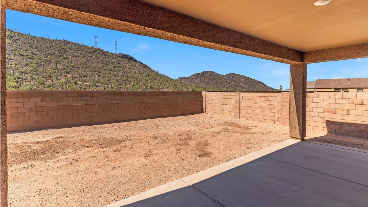 Welcome to The Citrine, a spacious single-story new home located in the tranquil Cholla Ridge neighborhood of Saguaro Bloom. With 2,577 square feet of well-planned living space, this home offers four bedrooms, three bathrooms, and a dedicated study, making it ideal for families who value both space and convenience.  As you enter through the inviting covered porch, you’re greeted by a bright and airy entryway that flows into the heart of the home. The expansive great room, dining area, and kitchen are thoughtfully connected, creating an ideal space for entertaining or simply enjoying time with family. The kitchen is a chef's dream, featuring a large island, granite countertops, and Shaker-style cabinetry in double espresso. A spacious pantry and modern stainless steel gas appliances ensure that this kitchen is both functional and stylish.  The Citrine’s layout includes a generously sized primary bedroom, carefully positioned for privacy at the rear of the home. This room features a large walk-in closet and an en-suite bathroom with dual executive-height vanities and a luxurious super shower. The additional three bedrooms are well-sized and located in separate areas of the home, ensuring privacy and easy access to two more full bathrooms.  One of the highlights of The Citrine is its versatile study, which can be used as a home office, library, media room, or extra bedroom depending on your needs. The large laundry room, conveniently situated near the bedrooms, adds to the home’s practicality.  The covered patio, accessible from the great room, offers a perfect spot for outdoor living, where you can enjoy Arizona’s beautiful weather throughout the year. Whether you’re hosting a barbecue or simply relaxing, this outdoor space enhances the home’s appeal.  Designed with energy efficiency and modern living in mind, The Citrine includes eco-friendly features and smart home technology, ensuring comfort and sustainability. Large windows throughout the home allow natural light to brighten every corner, creating a warm and welcoming atmosphere.  Located within the exclusive Cholla Ridge neighborhood at Saguaro Bloom, residents of The Citrine enjoy a range of premium features, including beautiful 12x24” tile flooring, gourmet kitchens, and 10’ ceilings in select homes. The community offers access to two pools, walking trails, parks, and more, all set against the picturesque backdrop of the Tucson Mountains.  The Citrine combines style, comfort, and practicality, making it a perfect place to call home in one of Marana’s most sought-after communities.