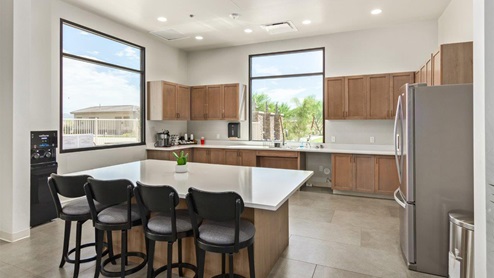 Explore New Homes at Saguaro Bloom by D.R. Horton – A Master-Planned Community in Marana, AZ. Nestled in the foothills of the breathtaking Tucson Mountains, Saguaro Bloom by D.R. Horton is a premier master-planned community in Northwest Marana that offers an exceptional living experience. Saguaro Bloom is divided into distinct neighborhoods, each offering its unique charm and amenities. *Mesquite at Saguaro Bloom* is located in Block 1 and offers a variety of spacious floorplans with 18x18 tile flooring, granite countertops in kitchen and bathrooms, and Shaker-style cabinets in white or gray. These homes feature 9’ ceilings on the first floor, island kitchens, and the Home is Connected® Smart Home package, making them perfect for modern living. *Agave at Saguaro Bloom*, situated in Block 7C, features homes with stunning 6x36” wood-look tile in gray, quartz countertops in kitchen and bathrooms, and Shaker-style cabinets. These homes are designed with stylish interiors and modern conveniences, including LED disc lighting and energy-efficient tankless water heaters. *Cholla Ridge at Saguaro Bloom*, located in Block 7B, offers single-story homes on lots with no rear neighbors. These homes are distinguished by beautiful 12x24” tile flooring, gourmet kitchens, and 10’ ceilings in select homes. With 8’ sliding glass patio doors and super showers, Cholla Ridge combines luxury and privacy in a serene setting. All homes in Saguaro Bloom are built with a Spanish lace stucco exterior, tile roofs, landscaped front yards with auto drip irrigation, and large, fully fenced backyards ready for your design. The homes also include covered front porches and back patios, stainless steel gas appliances, and executive height vanities in all bathrooms. Additionally, as of August 2024, all homes starting production are Zero Energy Ready, meeting rigorous energy efficiency standards that significantly reduce energy costs and environmental impact. Residents of Saguaro Bloom enjoy an array of community amenities, including a clubhouse, two pools with lap lanes and lagoon entry, a fitness center, a splash pad, and over 30 miles of walking trails. The community also features more than 20 pocket parks, playgrounds, and coming soon, a large community park with tennis, pickleball, soccer, baseball, and a dog park. Saguaro Bloom is truly a lifestyle community, offering regular events like Food Truck Thursdays, Movies at the Pool, and holiday decorating contests, all fostering a strong sense of community. Located in the highly-rated Marana Unified School District, Saguaro Bloom is close to excellent schools, including Rattlesnake Ridge Elementary, Marana Middle School, and Marana High School. The community’s location offers a perfect balance of seclusion and convenience, with quick access to I-10, grocery stores, restaurants, and the Twin Peaks Outlet, all within minutes. Downtown Tucson, with its vibrant arts, culture, and entertainment scene, is just a short 15-minute drive away. Surrounded by the natural beauty of the desert landscape, residents can explore nearby outdoor attractions like Saguaro National Park West, the Arizona Desert Museum, and Quarry Pines Golf Course. Whether you enjoy hiking, biking, or simply taking in the stunning views, Saguaro Bloom offers an unparalleled lifestyle in one of Arizona’s most sought-after locations. Discover the perfect blend of modern amenities, scenic beauty, and a strong sense of community at Saguaro Bloom by D.R. Horton – where your new home awaits in Marana, AZ.
