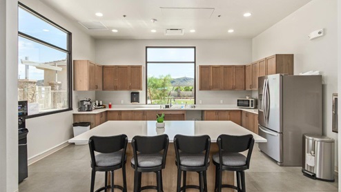 Explore New Homes at Saguaro Bloom by D.R. Horton – A Master-Planned Community in Marana, AZ. Nestled in the foothills of the breathtaking Tucson Mountains, Saguaro Bloom by D.R. Horton is a premier master-planned community in Northwest Marana that offers an exceptional living experience. Saguaro Bloom is divided into distinct neighborhoods, each offering its unique charm and amenities. *Mesquite at Saguaro Bloom* is located in Block 1 and offers a variety of spacious floorplans with 18x18 tile flooring, granite countertops in kitchen and bathrooms, and Shaker-style cabinets in white or gray. These homes feature 9’ ceilings on the first floor, island kitchens, and the Home is Connected® Smart Home package, making them perfect for modern living. *Agave at Saguaro Bloom*, situated in Block 7C, features homes with stunning 6x36” wood-look tile in gray, quartz countertops in kitchen and bathrooms, and Shaker-style cabinets. These homes are designed with stylish interiors and modern conveniences, including LED disc lighting and energy-efficient tankless water heaters. *Cholla Ridge at Saguaro Bloom*, located in Block 7B, offers single-story homes on lots with no rear neighbors. These homes are distinguished by beautiful 12x24” tile flooring, gourmet kitchens, and 10’ ceilings in select homes. With 8’ sliding glass patio doors and super showers, Cholla Ridge combines luxury and privacy in a serene setting. All homes in Saguaro Bloom are built with a Spanish lace stucco exterior, tile roofs, landscaped front yards with auto drip irrigation, and large, fully fenced backyards ready for your design. The homes also include covered front porches and back patios, stainless steel gas appliances, and executive height vanities in all bathrooms. Additionally, as of August 2024, all homes starting production are Zero Energy Ready, meeting rigorous energy efficiency standards that significantly reduce energy costs and environmental impact. Residents of Saguaro Bloom enjoy an array of community amenities, including a clubhouse, two pools with lap lanes and lagoon entry, a fitness center, a splash pad, and over 30 miles of walking trails. The community also features more than 20 pocket parks, playgrounds, and coming soon, a large community park with tennis, pickleball, soccer, baseball, and a dog park. Saguaro Bloom is truly a lifestyle community, offering regular events like Food Truck Thursdays, Movies at the Pool, and holiday decorating contests, all fostering a strong sense of community. Located in the highly-rated Marana Unified School District, Saguaro Bloom is close to excellent schools, including Rattlesnake Ridge Elementary, Marana Middle School, and Marana High School. The community’s location offers a perfect balance of seclusion and convenience, with quick access to I-10, grocery stores, restaurants, and the Twin Peaks Outlet, all within minutes. Downtown Tucson, with its vibrant arts, culture, and entertainment scene, is just a short 15-minute drive away. Surrounded by the natural beauty of the desert landscape, residents can explore nearby outdoor attractions like Saguaro National Park West, the Arizona Desert Museum, and Quarry Pines Golf Course. Whether you enjoy hiking, biking, or simply taking in the stunning views, Saguaro Bloom offers an unparalleled lifestyle in one of Arizona’s most sought-after locations. Discover the perfect blend of modern amenities, scenic beauty, and a strong sense of community at Saguaro Bloom by D.R. Horton – where your new home awaits in Marana, AZ.