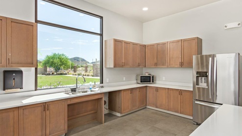 Explore New Homes at Saguaro Bloom by D.R. Horton – A Master-Planned Community in Marana, AZ. Nestled in the foothills of the breathtaking Tucson Mountains, Saguaro Bloom by D.R. Horton is a premier master-planned community in Northwest Marana that offers an exceptional living experience. Saguaro Bloom is divided into distinct neighborhoods, each offering its unique charm and amenities. *Mesquite at Saguaro Bloom* is located in Block 1 and offers a variety of spacious floorplans with 18x18 tile flooring, granite countertops in kitchen and bathrooms, and Shaker-style cabinets in white or gray. These homes feature 9’ ceilings on the first floor, island kitchens, and the Home is Connected® Smart Home package, making them perfect for modern living. *Agave at Saguaro Bloom*, situated in Block 7C, features homes with stunning 6x36” wood-look tile in gray, quartz countertops in kitchen and bathrooms, and Shaker-style cabinets. These homes are designed with stylish interiors and modern conveniences, including LED disc lighting and energy-efficient tankless water heaters. *Cholla Ridge at Saguaro Bloom*, located in Block 7B, offers single-story homes on lots with no rear neighbors. These homes are distinguished by beautiful 12x24” tile flooring, gourmet kitchens, and 10’ ceilings in select homes. With 8’ sliding glass patio doors and super showers, Cholla Ridge combines luxury and privacy in a serene setting. All homes in Saguaro Bloom are built with a Spanish lace stucco exterior, tile roofs, landscaped front yards with auto drip irrigation, and large, fully fenced backyards ready for your design. The homes also include covered front porches and back patios, stainless steel gas appliances, and executive height vanities in all bathrooms. Additionally, as of August 2024, all homes starting production are Zero Energy Ready, meeting rigorous energy efficiency standards that significantly reduce energy costs and environmental impact. Residents of Saguaro Bloom enjoy an array of community amenities, including a clubhouse, two pools with lap lanes and lagoon entry, a fitness center, a splash pad, and over 30 miles of walking trails. The community also features more than 20 pocket parks, playgrounds, and coming soon, a large community park with tennis, pickleball, soccer, baseball, and a dog park. Saguaro Bloom is truly a lifestyle community, offering regular events like Food Truck Thursdays, Movies at the Pool, and holiday decorating contests, all fostering a strong sense of community. Located in the highly-rated Marana Unified School District, Saguaro Bloom is close to excellent schools, including Rattlesnake Ridge Elementary, Marana Middle School, and Marana High School. The community’s location offers a perfect balance of seclusion and convenience, with quick access to I-10, grocery stores, restaurants, and the Twin Peaks Outlet, all within minutes. Downtown Tucson, with its vibrant arts, culture, and entertainment scene, is just a short 15-minute drive away. Surrounded by the natural beauty of the desert landscape, residents can explore nearby outdoor attractions like Saguaro National Park West, the Arizona Desert Museum, and Quarry Pines Golf Course. Whether you enjoy hiking, biking, or simply taking in the stunning views, Saguaro Bloom offers an unparalleled lifestyle in one of Arizona’s most sought-after locations. Discover the perfect blend of modern amenities, scenic beauty, and a strong sense of community at Saguaro Bloom by D.R. Horton – where your new home awaits in Marana, AZ.