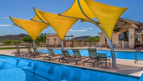 Explore New Homes at Saguaro Bloom by D.R. Horton – A Master-Planned Community in Marana, AZ. Nestled in the foothills of the breathtaking Tucson Mountains, Saguaro Bloom by D.R. Horton is a premier master-planned community in Northwest Marana that offers an exceptional living experience. Saguaro Bloom is divided into distinct neighborhoods, each offering its unique charm and amenities. *Mesquite at Saguaro Bloom* is located in Block 1 and offers a variety of spacious floorplans with 18x18 tile flooring, granite countertops in kitchen and bathrooms, and Shaker-style cabinets in white or gray. These homes feature 9’ ceilings on the first floor, island kitchens, and the Home is Connected® Smart Home package, making them perfect for modern living. *Agave at Saguaro Bloom*, situated in Block 7C, features homes with stunning 6x36” wood-look tile in gray, quartz countertops in kitchen and bathrooms, and Shaker-style cabinets. These homes are designed with stylish interiors and modern conveniences, including LED disc lighting and energy-efficient tankless water heaters. *Cholla Ridge at Saguaro Bloom*, located in Block 7B, offers single-story homes on lots with no rear neighbors. These homes are distinguished by beautiful 12x24” tile flooring, gourmet kitchens, and 10’ ceilings in select homes. With 8’ sliding glass patio doors and super showers, Cholla Ridge combines luxury and privacy in a serene setting. All homes in Saguaro Bloom are built with a Spanish lace stucco exterior, tile roofs, landscaped front yards with auto drip irrigation, and large, fully fenced backyards ready for your design. The homes also include covered front porches and back patios, stainless steel gas appliances, and executive height vanities in all bathrooms. Additionally, as of August 2024, all homes starting production are Zero Energy Ready, meeting rigorous energy efficiency standards that significantly reduce energy costs and environmental impact. Residents of Saguaro Bloom enjoy an array of community amenities, including a clubhouse, two pools with lap lanes and lagoon entry, a fitness center, a splash pad, and over 30 miles of walking trails. The community also features more than 20 pocket parks, playgrounds, and coming soon, a large community park with tennis, pickleball, soccer, baseball, and a dog park. Saguaro Bloom is truly a lifestyle community, offering regular events like Food Truck Thursdays, Movies at the Pool, and holiday decorating contests, all fostering a strong sense of community. Located in the highly-rated Marana Unified School District, Saguaro Bloom is close to excellent schools, including Rattlesnake Ridge Elementary, Marana Middle School, and Marana High School. The community’s location offers a perfect balance of seclusion and convenience, with quick access to I-10, grocery stores, restaurants, and the Twin Peaks Outlet, all within minutes. Downtown Tucson, with its vibrant arts, culture, and entertainment scene, is just a short 15-minute drive away. Surrounded by the natural beauty of the desert landscape, residents can explore nearby outdoor attractions like Saguaro National Park West, the Arizona Desert Museum, and Quarry Pines Golf Course. Whether you enjoy hiking, biking, or simply taking in the stunning views, Saguaro Bloom offers an unparalleled lifestyle in one of Arizona’s most sought-after locations. Discover the perfect blend of modern amenities, scenic beauty, and a strong sense of community at Saguaro Bloom by D.R. Horton – where your new home awaits in Marana, AZ.