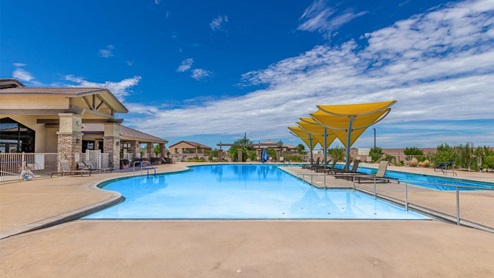 Explore New Homes at Saguaro Bloom by D.R. Horton – A Master-Planned Community in Marana, AZ. Nestled in the foothills of the breathtaking Tucson Mountains, Saguaro Bloom by D.R. Horton is a premier master-planned community in Northwest Marana that offers an exceptional living experience. Saguaro Bloom is divided into distinct neighborhoods, each offering its unique charm and amenities. *Mesquite at Saguaro Bloom* is located in Block 1 and offers a variety of spacious floorplans with 18x18 tile flooring, granite countertops in kitchen and bathrooms, and Shaker-style cabinets in white or gray. These homes feature 9’ ceilings on the first floor, island kitchens, and the Home is Connected® Smart Home package, making them perfect for modern living. *Agave at Saguaro Bloom*, situated in Block 7C, features homes with stunning 6x36” wood-look tile in gray, quartz countertops in kitchen and bathrooms, and Shaker-style cabinets. These homes are designed with stylish interiors and modern conveniences, including LED disc lighting and energy-efficient tankless water heaters. *Cholla Ridge at Saguaro Bloom*, located in Block 7B, offers single-story homes on lots with no rear neighbors. These homes are distinguished by beautiful 12x24” tile flooring, gourmet kitchens, and 10’ ceilings in select homes. With 8’ sliding glass patio doors and super showers, Cholla Ridge combines luxury and privacy in a serene setting. All homes in Saguaro Bloom are built with a Spanish lace stucco exterior, tile roofs, landscaped front yards with auto drip irrigation, and large, fully fenced backyards ready for your design. The homes also include covered front porches and back patios, stainless steel gas appliances, and executive height vanities in all bathrooms. Additionally, as of August 2024, all homes starting production are Zero Energy Ready, meeting rigorous energy efficiency standards that significantly reduce energy costs and environmental impact. Residents of Saguaro Bloom enjoy an array of community amenities, including a clubhouse, two pools with lap lanes and lagoon entry, a fitness center, a splash pad, and over 30 miles of walking trails. The community also features more than 20 pocket parks, playgrounds, and coming soon, a large community park with tennis, pickleball, soccer, baseball, and a dog park. Saguaro Bloom is truly a lifestyle community, offering regular events like Food Truck Thursdays, Movies at the Pool, and holiday decorating contests, all fostering a strong sense of community. Located in the highly-rated Marana Unified School District, Saguaro Bloom is close to excellent schools, including Rattlesnake Ridge Elementary, Marana Middle School, and Marana High School. The community’s location offers a perfect balance of seclusion and convenience, with quick access to I-10, grocery stores, restaurants, and the Twin Peaks Outlet, all within minutes. Downtown Tucson, with its vibrant arts, culture, and entertainment scene, is just a short 15-minute drive away. Surrounded by the natural beauty of the desert landscape, residents can explore nearby outdoor attractions like Saguaro National Park West, the Arizona Desert Museum, and Quarry Pines Golf Course. Whether you enjoy hiking, biking, or simply taking in the stunning views, Saguaro Bloom offers an unparalleled lifestyle in one of Arizona’s most sought-after locations. Discover the perfect blend of modern amenities, scenic beauty, and a strong sense of community at Saguaro Bloom by D.R. Horton – where your new home awaits in Marana, AZ.