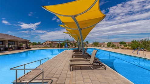 Explore New Homes at Saguaro Bloom by D.R. Horton – A Master-Planned Community in Marana, AZ. Nestled in the foothills of the breathtaking Tucson Mountains, Saguaro Bloom by D.R. Horton is a premier master-planned community in Northwest Marana that offers an exceptional living experience. Saguaro Bloom is divided into distinct neighborhoods, each offering its unique charm and amenities. *Mesquite at Saguaro Bloom* is located in Block 1 and offers a variety of spacious floorplans with 18x18 tile flooring, granite countertops in kitchen and bathrooms, and Shaker-style cabinets in white or gray. These homes feature 9’ ceilings on the first floor, island kitchens, and the Home is Connected® Smart Home package, making them perfect for modern living. *Agave at Saguaro Bloom*, situated in Block 7C, features homes with stunning 6x36” wood-look tile in gray, quartz countertops in kitchen and bathrooms, and Shaker-style cabinets. These homes are designed with stylish interiors and modern conveniences, including LED disc lighting and energy-efficient tankless water heaters. *Cholla Ridge at Saguaro Bloom*, located in Block 7B, offers single-story homes on lots with no rear neighbors. These homes are distinguished by beautiful 12x24” tile flooring, gourmet kitchens, and 10’ ceilings in select homes. With 8’ sliding glass patio doors and super showers, Cholla Ridge combines luxury and privacy in a serene setting. All homes in Saguaro Bloom are built with a Spanish lace stucco exterior, tile roofs, landscaped front yards with auto drip irrigation, and large, fully fenced backyards ready for your design. The homes also include covered front porches and back patios, stainless steel gas appliances, and executive height vanities in all bathrooms. Additionally, as of August 2024, all homes starting production are Zero Energy Ready, meeting rigorous energy efficiency standards that significantly reduce energy costs and environmental impact. Residents of Saguaro Bloom enjoy an array of community amenities, including a clubhouse, two pools with lap lanes and lagoon entry, a fitness center, a splash pad, and over 30 miles of walking trails. The community also features more than 20 pocket parks, playgrounds, and coming soon, a large community park with tennis, pickleball, soccer, baseball, and a dog park. Saguaro Bloom is truly a lifestyle community, offering regular events like Food Truck Thursdays, Movies at the Pool, and holiday decorating contests, all fostering a strong sense of community. Located in the highly-rated Marana Unified School District, Saguaro Bloom is close to excellent schools, including Rattlesnake Ridge Elementary, Marana Middle School, and Marana High School. The community’s location offers a perfect balance of seclusion and convenience, with quick access to I-10, grocery stores, restaurants, and the Twin Peaks Outlet, all within minutes. Downtown Tucson, with its vibrant arts, culture, and entertainment scene, is just a short 15-minute drive away. Surrounded by the natural beauty of the desert landscape, residents can explore nearby outdoor attractions like Saguaro National Park West, the Arizona Desert Museum, and Quarry Pines Golf Course. Whether you enjoy hiking, biking, or simply taking in the stunning views, Saguaro Bloom offers an unparalleled lifestyle in one of Arizona’s most sought-after locations. Discover the perfect blend of modern amenities, scenic beauty, and a strong sense of community at Saguaro Bloom by D.R. Horton – where your new home awaits in Marana, AZ.