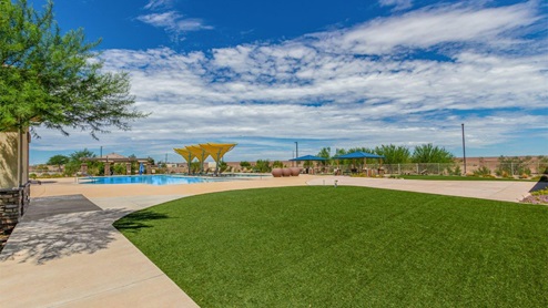Explore New Homes at Saguaro Bloom by D.R. Horton – A Master-Planned Community in Marana, AZ. Nestled in the foothills of the breathtaking Tucson Mountains, Saguaro Bloom by D.R. Horton is a premier master-planned community in Northwest Marana that offers an exceptional living experience. Saguaro Bloom is divided into distinct neighborhoods, each offering its unique charm and amenities. *Mesquite at Saguaro Bloom* is located in Block 1 and offers a variety of spacious floorplans with 18x18 tile flooring, granite countertops in kitchen and bathrooms, and Shaker-style cabinets in white or gray. These homes feature 9’ ceilings on the first floor, island kitchens, and the Home is Connected® Smart Home package, making them perfect for modern living. *Agave at Saguaro Bloom*, situated in Block 7C, features homes with stunning 6x36” wood-look tile in gray, quartz countertops in kitchen and bathrooms, and Shaker-style cabinets. These homes are designed with stylish interiors and modern conveniences, including LED disc lighting and energy-efficient tankless water heaters. *Cholla Ridge at Saguaro Bloom*, located in Block 7B, offers single-story homes on lots with no rear neighbors. These homes are distinguished by beautiful 12x24” tile flooring, gourmet kitchens, and 10’ ceilings in select homes. With 8’ sliding glass patio doors and super showers, Cholla Ridge combines luxury and privacy in a serene setting. All homes in Saguaro Bloom are built with a Spanish lace stucco exterior, tile roofs, landscaped front yards with auto drip irrigation, and large, fully fenced backyards ready for your design. The homes also include covered front porches and back patios, stainless steel gas appliances, and executive height vanities in all bathrooms. Additionally, as of August 2024, all homes starting production are Zero Energy Ready, meeting rigorous energy efficiency standards that significantly reduce energy costs and environmental impact. Residents of Saguaro Bloom enjoy an array of community amenities, including a clubhouse, two pools with lap lanes and lagoon entry, a fitness center, a splash pad, and over 30 miles of walking trails. The community also features more than 20 pocket parks, playgrounds, and coming soon, a large community park with tennis, pickleball, soccer, baseball, and a dog park. Saguaro Bloom is truly a lifestyle community, offering regular events like Food Truck Thursdays, Movies at the Pool, and holiday decorating contests, all fostering a strong sense of community. Located in the highly-rated Marana Unified School District, Saguaro Bloom is close to excellent schools, including Rattlesnake Ridge Elementary, Marana Middle School, and Marana High School. The community’s location offers a perfect balance of seclusion and convenience, with quick access to I-10, grocery stores, restaurants, and the Twin Peaks Outlet, all within minutes. Downtown Tucson, with its vibrant arts, culture, and entertainment scene, is just a short 15-minute drive away. Surrounded by the natural beauty of the desert landscape, residents can explore nearby outdoor attractions like Saguaro National Park West, the Arizona Desert Museum, and Quarry Pines Golf Course. Whether you enjoy hiking, biking, or simply taking in the stunning views, Saguaro Bloom offers an unparalleled lifestyle in one of Arizona’s most sought-after locations. Discover the perfect blend of modern amenities, scenic beauty, and a strong sense of community at Saguaro Bloom by D.R. Horton – where your new home awaits in Marana, AZ.