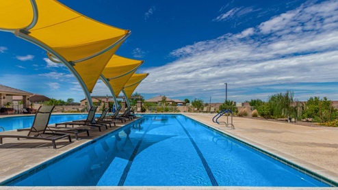 Explore New Homes at Saguaro Bloom by D.R. Horton – A Master-Planned Community in Marana, AZ. Nestled in the foothills of the breathtaking Tucson Mountains, Saguaro Bloom by D.R. Horton is a premier master-planned community in Northwest Marana that offers an exceptional living experience. Saguaro Bloom is divided into distinct neighborhoods, each offering its unique charm and amenities. *Mesquite at Saguaro Bloom* is located in Block 1 and offers a variety of spacious floorplans with 18x18 tile flooring, granite countertops in kitchen and bathrooms, and Shaker-style cabinets in white or gray. These homes feature 9’ ceilings on the first floor, island kitchens, and the Home is Connected® Smart Home package, making them perfect for modern living. *Agave at Saguaro Bloom*, situated in Block 7C, features homes with stunning 6x36” wood-look tile in gray, quartz countertops in kitchen and bathrooms, and Shaker-style cabinets. These homes are designed with stylish interiors and modern conveniences, including LED disc lighting and energy-efficient tankless water heaters. *Cholla Ridge at Saguaro Bloom*, located in Block 7B, offers single-story homes on lots with no rear neighbors. These homes are distinguished by beautiful 12x24” tile flooring, gourmet kitchens, and 10’ ceilings in select homes. With 8’ sliding glass patio doors and super showers, Cholla Ridge combines luxury and privacy in a serene setting. All homes in Saguaro Bloom are built with a Spanish lace stucco exterior, tile roofs, landscaped front yards with auto drip irrigation, and large, fully fenced backyards ready for your design. The homes also include covered front porches and back patios, stainless steel gas appliances, and executive height vanities in all bathrooms. Additionally, as of August 2024, all homes starting production are Zero Energy Ready, meeting rigorous energy efficiency standards that significantly reduce energy costs and environmental impact. Residents of Saguaro Bloom enjoy an array of community amenities, including a clubhouse, two pools with lap lanes and lagoon entry, a fitness center, a splash pad, and over 30 miles of walking trails. The community also features more than 20 pocket parks, playgrounds, and coming soon, a large community park with tennis, pickleball, soccer, baseball, and a dog park. Saguaro Bloom is truly a lifestyle community, offering regular events like Food Truck Thursdays, Movies at the Pool, and holiday decorating contests, all fostering a strong sense of community. Located in the highly-rated Marana Unified School District, Saguaro Bloom is close to excellent schools, including Rattlesnake Ridge Elementary, Marana Middle School, and Marana High School. The community’s location offers a perfect balance of seclusion and convenience, with quick access to I-10, grocery stores, restaurants, and the Twin Peaks Outlet, all within minutes. Downtown Tucson, with its vibrant arts, culture, and entertainment scene, is just a short 15-minute drive away. Surrounded by the natural beauty of the desert landscape, residents can explore nearby outdoor attractions like Saguaro National Park West, the Arizona Desert Museum, and Quarry Pines Golf Course. Whether you enjoy hiking, biking, or simply taking in the stunning views, Saguaro Bloom offers an unparalleled lifestyle in one of Arizona’s most sought-after locations. Discover the perfect blend of modern amenities, scenic beauty, and a strong sense of community at Saguaro Bloom by D.R. Horton – where your new home awaits in Marana, AZ.