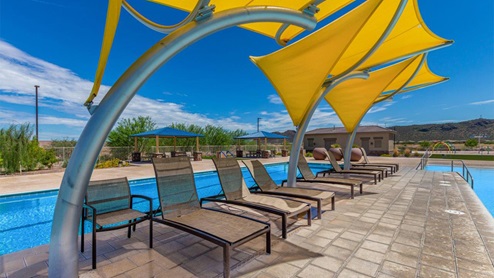 Explore New Homes at Saguaro Bloom by D.R. Horton – A Master-Planned Community in Marana, AZ. Nestled in the foothills of the breathtaking Tucson Mountains, Saguaro Bloom by D.R. Horton is a premier master-planned community in Northwest Marana that offers an exceptional living experience. Saguaro Bloom is divided into distinct neighborhoods, each offering its unique charm and amenities. *Mesquite at Saguaro Bloom* is located in Block 1 and offers a variety of spacious floorplans with 18x18 tile flooring, granite countertops in kitchen and bathrooms, and Shaker-style cabinets in white or gray. These homes feature 9’ ceilings on the first floor, island kitchens, and the Home is Connected® Smart Home package, making them perfect for modern living. *Agave at Saguaro Bloom*, situated in Block 7C, features homes with stunning 6x36” wood-look tile in gray, quartz countertops in kitchen and bathrooms, and Shaker-style cabinets. These homes are designed with stylish interiors and modern conveniences, including LED disc lighting and energy-efficient tankless water heaters. *Cholla Ridge at Saguaro Bloom*, located in Block 7B, offers single-story homes on lots with no rear neighbors. These homes are distinguished by beautiful 12x24” tile flooring, gourmet kitchens, and 10’ ceilings in select homes. With 8’ sliding glass patio doors and super showers, Cholla Ridge combines luxury and privacy in a serene setting. All homes in Saguaro Bloom are built with a Spanish lace stucco exterior, tile roofs, landscaped front yards with auto drip irrigation, and large, fully fenced backyards ready for your design. The homes also include covered front porches and back patios, stainless steel gas appliances, and executive height vanities in all bathrooms. Additionally, as of August 2024, all homes starting production are Zero Energy Ready, meeting rigorous energy efficiency standards that significantly reduce energy costs and environmental impact. Residents of Saguaro Bloom enjoy an array of community amenities, including a clubhouse, two pools with lap lanes and lagoon entry, a fitness center, a splash pad, and over 30 miles of walking trails. The community also features more than 20 pocket parks, playgrounds, and coming soon, a large community park with tennis, pickleball, soccer, baseball, and a dog park. Saguaro Bloom is truly a lifestyle community, offering regular events like Food Truck Thursdays, Movies at the Pool, and holiday decorating contests, all fostering a strong sense of community. Located in the highly-rated Marana Unified School District, Saguaro Bloom is close to excellent schools, including Rattlesnake Ridge Elementary, Marana Middle School, and Marana High School. The community’s location offers a perfect balance of seclusion and convenience, with quick access to I-10, grocery stores, restaurants, and the Twin Peaks Outlet, all within minutes. Downtown Tucson, with its vibrant arts, culture, and entertainment scene, is just a short 15-minute drive away. Surrounded by the natural beauty of the desert landscape, residents can explore nearby outdoor attractions like Saguaro National Park West, the Arizona Desert Museum, and Quarry Pines Golf Course. Whether you enjoy hiking, biking, or simply taking in the stunning views, Saguaro Bloom offers an unparalleled lifestyle in one of Arizona’s most sought-after locations. Discover the perfect blend of modern amenities, scenic beauty, and a strong sense of community at Saguaro Bloom by D.R. Horton – where your new home awaits in Marana, AZ.