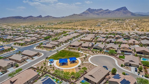 Explore New Homes at Saguaro Bloom by D.R. Horton – A Master-Planned Community in Marana, AZ. Nestled in the foothills of the breathtaking Tucson Mountains, Saguaro Bloom by D.R. Horton is a premier master-planned community in Northwest Marana that offers an exceptional living experience. Saguaro Bloom is divided into distinct neighborhoods, each offering its unique charm and amenities. *Mesquite at Saguaro Bloom* is located in Block 1 and offers a variety of spacious floorplans with 18x18 tile flooring, granite countertops in kitchen and bathrooms, and Shaker-style cabinets in white or gray. These homes feature 9’ ceilings on the first floor, island kitchens, and the Home is Connected® Smart Home package, making them perfect for modern living. *Agave at Saguaro Bloom*, situated in Block 7C, features homes with stunning 6x36” wood-look tile in gray, quartz countertops in kitchen and bathrooms, and Shaker-style cabinets. These homes are designed with stylish interiors and modern conveniences, including LED disc lighting and energy-efficient tankless water heaters. *Cholla Ridge at Saguaro Bloom*, located in Block 7B, offers single-story homes on lots with no rear neighbors. These homes are distinguished by beautiful 12x24” tile flooring, gourmet kitchens, and 10’ ceilings in select homes. With 8’ sliding glass patio doors and super showers, Cholla Ridge combines luxury and privacy in a serene setting. All homes in Saguaro Bloom are built with a Spanish lace stucco exterior, tile roofs, landscaped front yards with auto drip irrigation, and large, fully fenced backyards ready for your design. The homes also include covered front porches and back patios, stainless steel gas appliances, and executive height vanities in all bathrooms. Additionally, as of August 2024, all homes starting production are Zero Energy Ready, meeting rigorous energy efficiency standards that significantly reduce energy costs and environmental impact. Residents of Saguaro Bloom enjoy an array of community amenities, including a clubhouse, two pools with lap lanes and lagoon entry, a fitness center, a splash pad, and over 30 miles of walking trails. The community also features more than 20 pocket parks, playgrounds, and coming soon, a large community park with tennis, pickleball, soccer, baseball, and a dog park. Saguaro Bloom is truly a lifestyle community, offering regular events like Food Truck Thursdays, Movies at the Pool, and holiday decorating contests, all fostering a strong sense of community. Located in the highly-rated Marana Unified School District, Saguaro Bloom is close to excellent schools, including Rattlesnake Ridge Elementary, Marana Middle School, and Marana High School. The community’s location offers a perfect balance of seclusion and convenience, with quick access to I-10, grocery stores, restaurants, and the Twin Peaks Outlet, all within minutes. Downtown Tucson, with its vibrant arts, culture, and entertainment scene, is just a short 15-minute drive away. Surrounded by the natural beauty of the desert landscape, residents can explore nearby outdoor attractions like Saguaro National Park West, the Arizona Desert Museum, and Quarry Pines Golf Course. Whether you enjoy hiking, biking, or simply taking in the stunning views, Saguaro Bloom offers an unparalleled lifestyle in one of Arizona’s most sought-after locations. Discover the perfect blend of modern amenities, scenic beauty, and a strong sense of community at Saguaro Bloom by D.R. Horton – where your new home awaits in Marana, AZ.