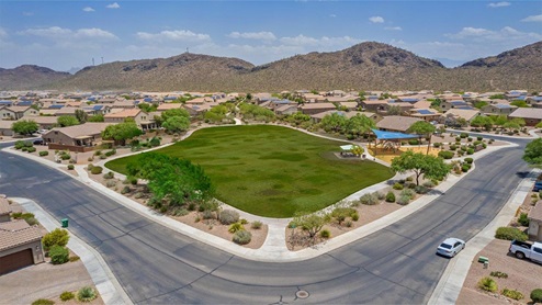 Explore New Homes at Saguaro Bloom by D.R. Horton – A Master-Planned Community in Marana, AZ. Nestled in the foothills of the breathtaking Tucson Mountains, Saguaro Bloom by D.R. Horton is a premier master-planned community in Northwest Marana that offers an exceptional living experience. Saguaro Bloom is divided into distinct neighborhoods, each offering its unique charm and amenities. *Mesquite at Saguaro Bloom* is located in Block 1 and offers a variety of spacious floorplans with 18x18 tile flooring, granite countertops in kitchen and bathrooms, and Shaker-style cabinets in white or gray. These homes feature 9’ ceilings on the first floor, island kitchens, and the Home is Connected® Smart Home package, making them perfect for modern living. *Agave at Saguaro Bloom*, situated in Block 7C, features homes with stunning 6x36” wood-look tile in gray, quartz countertops in kitchen and bathrooms, and Shaker-style cabinets. These homes are designed with stylish interiors and modern conveniences, including LED disc lighting and energy-efficient tankless water heaters. *Cholla Ridge at Saguaro Bloom*, located in Block 7B, offers single-story homes on lots with no rear neighbors. These homes are distinguished by beautiful 12x24” tile flooring, gourmet kitchens, and 10’ ceilings in select homes. With 8’ sliding glass patio doors and super showers, Cholla Ridge combines luxury and privacy in a serene setting. All homes in Saguaro Bloom are built with a Spanish lace stucco exterior, tile roofs, landscaped front yards with auto drip irrigation, and large, fully fenced backyards ready for your design. The homes also include covered front porches and back patios, stainless steel gas appliances, and executive height vanities in all bathrooms. Additionally, as of August 2024, all homes starting production are Zero Energy Ready, meeting rigorous energy efficiency standards that significantly reduce energy costs and environmental impact. Residents of Saguaro Bloom enjoy an array of community amenities, including a clubhouse, two pools with lap lanes and lagoon entry, a fitness center, a splash pad, and over 30 miles of walking trails. The community also features more than 20 pocket parks, playgrounds, and coming soon, a large community park with tennis, pickleball, soccer, baseball, and a dog park. Saguaro Bloom is truly a lifestyle community, offering regular events like Food Truck Thursdays, Movies at the Pool, and holiday decorating contests, all fostering a strong sense of community. Located in the highly-rated Marana Unified School District, Saguaro Bloom is close to excellent schools, including Rattlesnake Ridge Elementary, Marana Middle School, and Marana High School. The community’s location offers a perfect balance of seclusion and convenience, with quick access to I-10, grocery stores, restaurants, and the Twin Peaks Outlet, all within minutes. Downtown Tucson, with its vibrant arts, culture, and entertainment scene, is just a short 15-minute drive away. Surrounded by the natural beauty of the desert landscape, residents can explore nearby outdoor attractions like Saguaro National Park West, the Arizona Desert Museum, and Quarry Pines Golf Course. Whether you enjoy hiking, biking, or simply taking in the stunning views, Saguaro Bloom offers an unparalleled lifestyle in one of Arizona’s most sought-after locations. Discover the perfect blend of modern amenities, scenic beauty, and a strong sense of community at Saguaro Bloom by D.R. Horton – where your new home awaits in Marana, AZ.