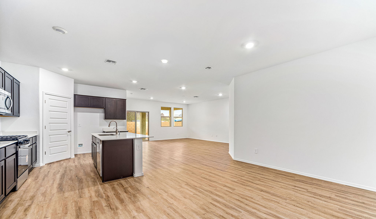 The Dalea is a standout single-story new home floorplan available in the Saguaro Bloom community in Marana, Arizona. Offering 2,224 square feet of living space, this home is designed to accommodate modern living with comfort and style. The Dalea provides a spacious layout with plenty of options such as four to five bedrooms and three full bathrooms, making it an ideal choice for families of all sizes.  As you step into the charming front porch, you are greeted by a spacious and open floor plan that seamlessly connects the main living areas. The great room serves as the central hub of the home, flowing into a dining area and modern kitchen area. The kitchen features a large central island, quartz countertops, Shaker-style cabinetry, walk-in pantry, and ample storage for all your culinary needs.  The primary suite, located at the rear of the home, provides a private retreat with a spacious bedroom, a large walk-in closet, and an en-suite bathroom and a walk-in shower. The Dalea floor plan also includes a utility room and two-car garage with the option of three-car tandem garage.  Living at Saguaro Bloom means more than just having a beautiful home. The community offers a peaceful lifestyle with incredible desert landscapes, mountain views, and easy access to I-10 for convenient commutes to Tucson and surrounding areas. Designed with energy efficiency in mind, The Dalea at Saguaro Bloom meets Zero Energy Ready Home standards, ensuring sustainability and long-term savings.  Step outside to the covered patio, perfect for enjoying the Arizona climate. Whether you're hosting a summer barbecue or simply unwinding in the evening, this outdoor space is a valuable addition to the home.  Residents of Saguaro Bloom enjoy an array of community amenities, including a clubhouse, two pools with lap lanes and lagoon entry, a fitness center, a splash pad, and over 30 miles of walking trails. This vibrant neighborhood is the perfect setting for those looking to enjoy the best of Arizona living.