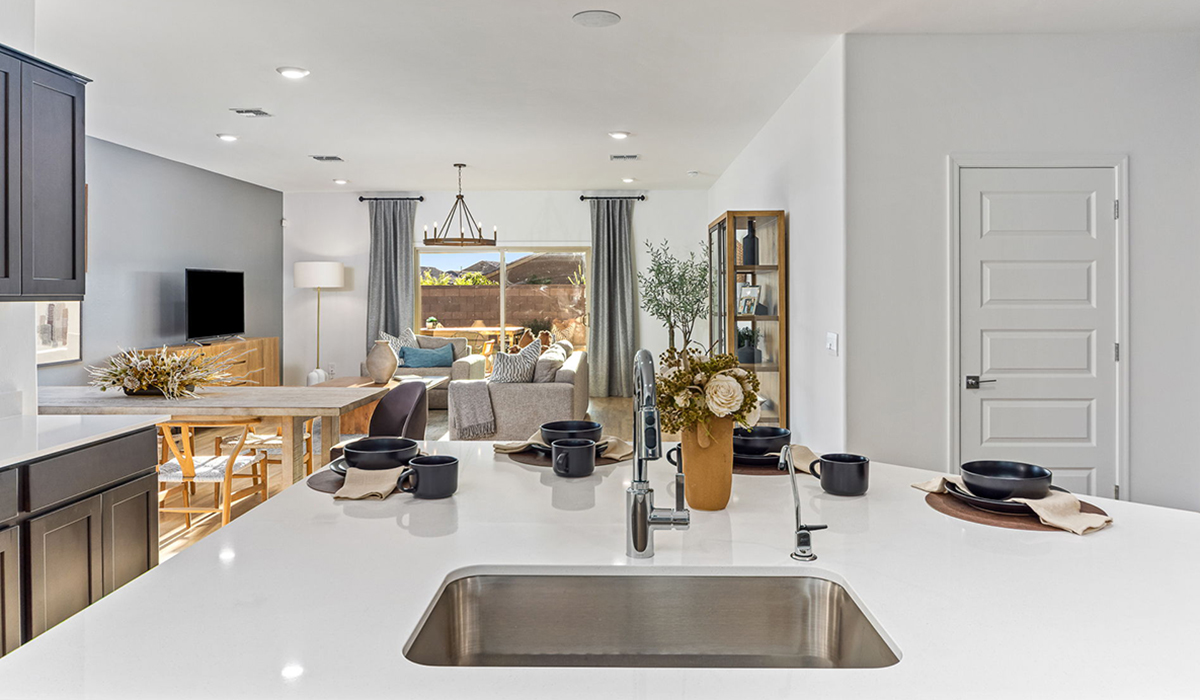 Welcome to the Kingston floor plan in the Agave neighborhood at Saguaro Bloom, Marana, Arizona—a perfect blend of comfort, modern living, and energy efficiency. This thoughtfully crafted one-story home spans 2,051 square feet and offers four bedrooms and two bathrooms, ideal for families of all sizes.  The open-concept design features a spacious great room that effortlessly connects with the kitchen and dining area, creating an inviting central hub for everyday living and entertaining. The kitchen is equipped with contemporary appliances and a pantry.  The primary bedroom, located at the rear of the home, provides a peaceful retreat with a private ensuite bathroom and a walk-in closet. The additional three bedrooms are positioned at the front of the house, offering versatility for use as guest rooms, a home office, or children’s bedrooms. Step outside to the covered patio, a perfect spot to enjoy the beautiful Arizona weather.  Built with energy efficiency as a priority, the Kingston includes smart home technology, which not only simplifies daily living but also helps reduce utility costs. A two-car garage provides ample parking and additional storage space, enhancing the home’s functionality.  Residents of Saguaro Bloom enjoy access to a range of community amenities, including parks, walking trails, and recreational facilities, making this home an ideal choice for those seeking a balanced lifestyle in a scenic setting.  *Images shown are for reference only. They depict The Kingston sales model home and may not represent the actual home.