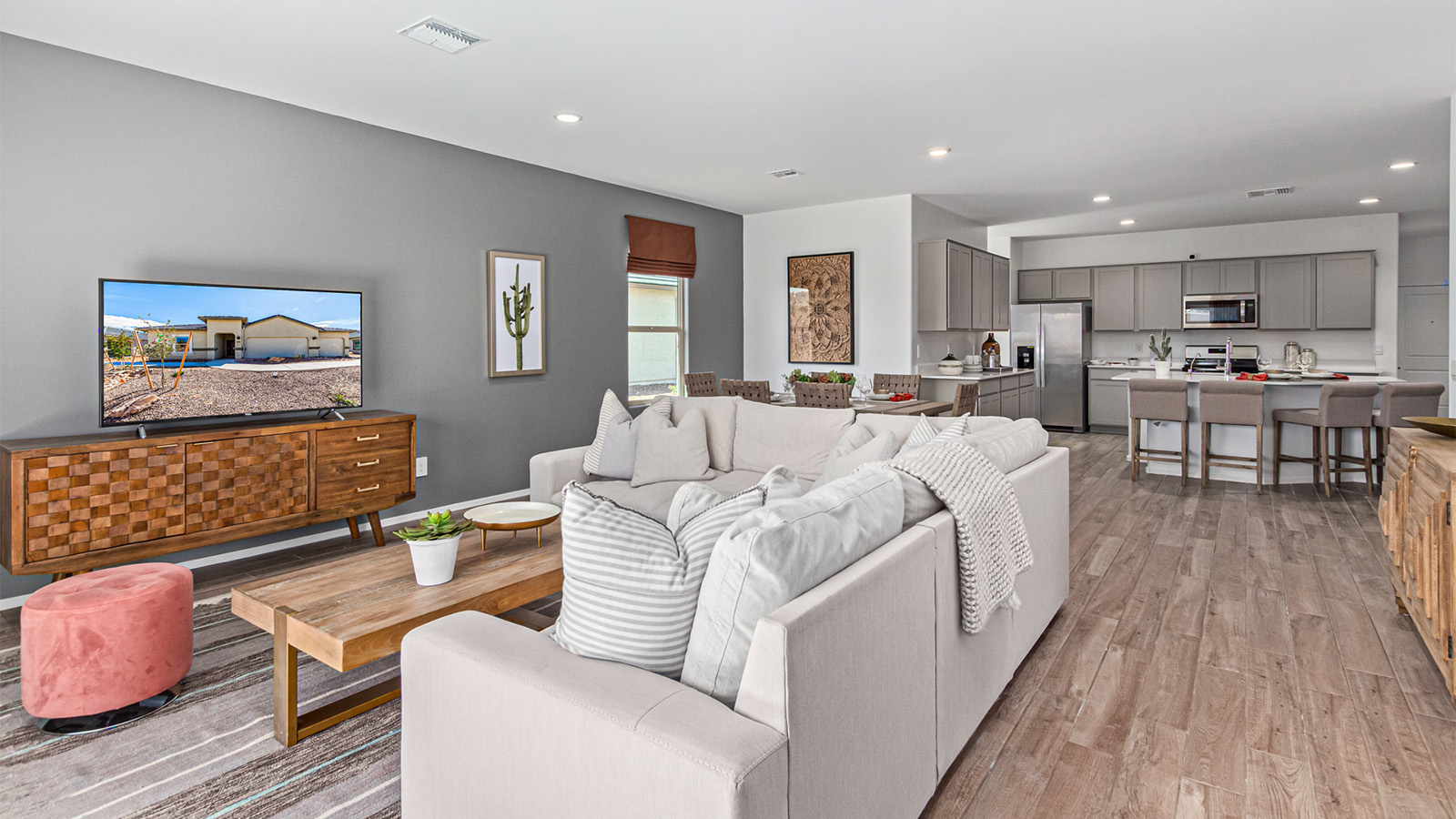 Welcome to the Kingston floor plan in the Agave neighborhood at Saguaro Bloom, Marana, Arizona—a perfect blend of comfort, modern living, and energy efficiency. This thoughtfully crafted one-story home spans 2,051 square feet and offers four bedrooms and two bathrooms, ideal for families of all sizes.  The open-concept design features a spacious great room that effortlessly connects with the kitchen and dining area, creating an inviting central hub for everyday living and entertaining. The kitchen is equipped with contemporary appliances and a pantry.  The primary bedroom, located at the rear of the home, provides a peaceful retreat with a private ensuite bathroom and a walk-in closet. The additional three bedrooms are positioned at the front of the house, offering versatility for use as guest rooms, a home office, or children’s bedrooms. Step outside to the covered patio, a perfect spot to enjoy the beautiful Arizona weather.  Built with energy efficiency as a priority, the Kingston includes smart home technology, which not only simplifies daily living but also helps reduce utility costs. A two-car garage provides ample parking and additional storage space, enhancing the home’s functionality.  Residents of Saguaro Bloom enjoy access to a range of community amenities, including parks, walking trails, and recreational facilities, making this home an ideal choice for those seeking a balanced lifestyle in a scenic setting.