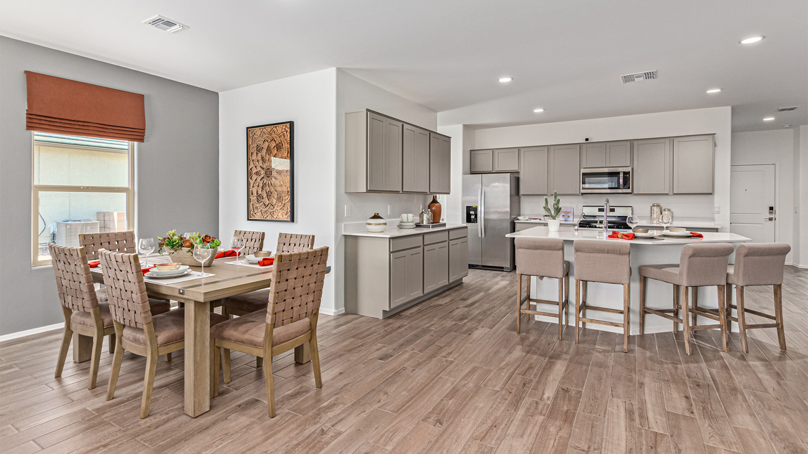 Welcome to the Kingston floor plan in the Agave neighborhood at Saguaro Bloom, Marana, Arizona—a perfect blend of comfort, modern living, and energy efficiency. This thoughtfully crafted one-story home spans 2,051 square feet and offers four bedrooms and two bathrooms, ideal for families of all sizes.  The open-concept design features a spacious great room that effortlessly connects with the kitchen and dining area, creating an inviting central hub for everyday living and entertaining. The kitchen is equipped with contemporary appliances and a pantry.  The primary bedroom, located at the rear of the home, provides a peaceful retreat with a private ensuite bathroom and a walk-in closet. The additional three bedrooms are positioned at the front of the house, offering versatility for use as guest rooms, a home office, or children’s bedrooms. Step outside to the covered patio, a perfect spot to enjoy the beautiful Arizona weather.  Built with energy efficiency as a priority, the Kingston includes smart home technology, which not only simplifies daily living but also helps reduce utility costs. A two-car garage provides ample parking and additional storage space, enhancing the home’s functionality.  Residents of Saguaro Bloom enjoy access to a range of community amenities, including parks, walking trails, and recreational facilities, making this home an ideal choice for those seeking a balanced lifestyle in a scenic setting.