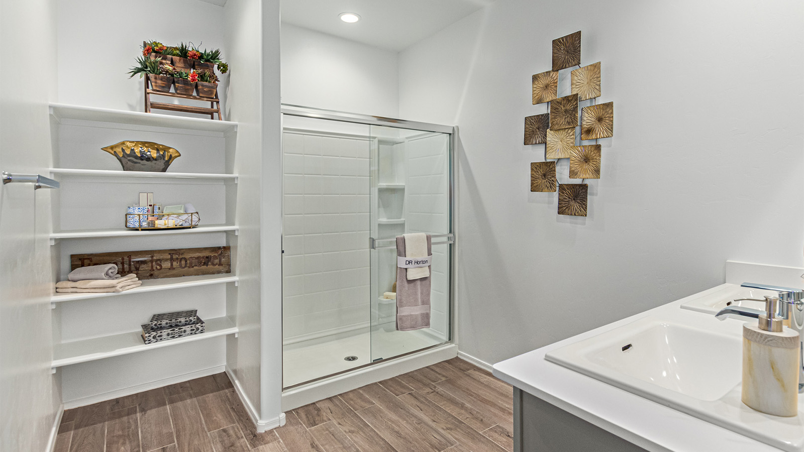 Welcome to the Kingston floor plan in the Agave neighborhood at Saguaro Bloom, Marana, Arizona—a perfect blend of comfort, modern living, and energy efficiency. This thoughtfully crafted one-story home spans 2,051 square feet and offers four bedrooms and two bathrooms, ideal for families of all sizes.  The open-concept design features a spacious great room that effortlessly connects with the kitchen and dining area, creating an inviting central hub for everyday living and entertaining. The kitchen is equipped with contemporary appliances and a pantry.  The primary bedroom, located at the rear of the home, provides a peaceful retreat with a private ensuite bathroom and a walk-in closet. The additional three bedrooms are positioned at the front of the house, offering versatility for use as guest rooms, a home office, or children’s bedrooms. Step outside to the covered patio, a perfect spot to enjoy the beautiful Arizona weather.  Built with energy efficiency as a priority, the Kingston includes smart home technology, which not only simplifies daily living but also helps reduce utility costs. A two-car garage provides ample parking and additional storage space, enhancing the home’s functionality.  Residents of Saguaro Bloom enjoy access to a range of community amenities, including parks, walking trails, and recreational facilities, making this home an ideal choice for those seeking a balanced lifestyle in a scenic setting.