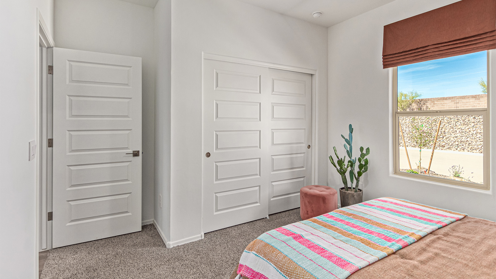 Welcome to the Kingston floor plan in the Agave neighborhood at Saguaro Bloom, Marana, Arizona—a perfect blend of comfort, modern living, and energy efficiency. This thoughtfully crafted one-story home spans 2,051 square feet and offers four bedrooms and two bathrooms, ideal for families of all sizes.  The open-concept design features a spacious great room that effortlessly connects with the kitchen and dining area, creating an inviting central hub for everyday living and entertaining. The kitchen is equipped with contemporary appliances and a pantry.  The primary bedroom, located at the rear of the home, provides a peaceful retreat with a private ensuite bathroom and a walk-in closet. The additional three bedrooms are positioned at the front of the house, offering versatility for use as guest rooms, a home office, or children’s bedrooms. Step outside to the covered patio, a perfect spot to enjoy the beautiful Arizona weather.  Built with energy efficiency as a priority, the Kingston includes smart home technology, which not only simplifies daily living but also helps reduce utility costs. A two-car garage provides ample parking and additional storage space, enhancing the home’s functionality.  Residents of Saguaro Bloom enjoy access to a range of community amenities, including parks, walking trails, and recreational facilities, making this home an ideal choice for those seeking a balanced lifestyle in a scenic setting.