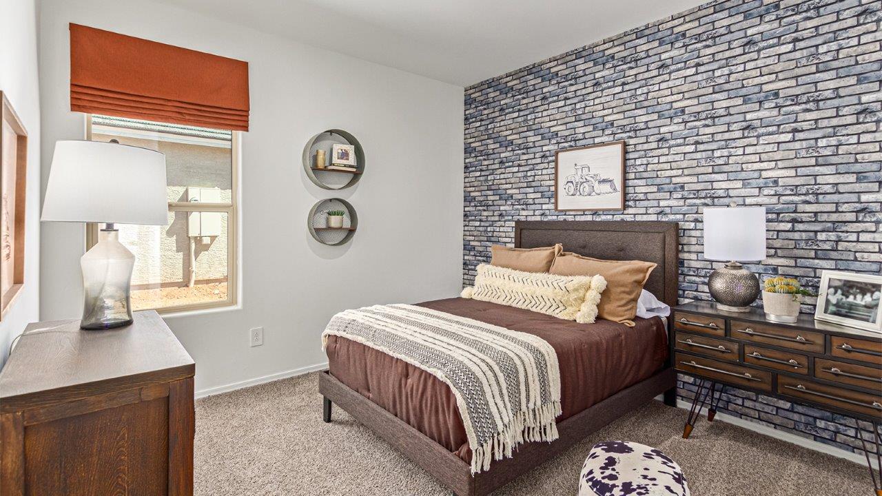 Welcome to the Kingston floor plan in the Agave neighborhood at Saguaro Bloom, Marana, Arizona—a perfect blend of comfort, modern living, and energy efficiency. This thoughtfully crafted one-story home spans 2,051 square feet and offers four bedrooms and two bathrooms, ideal for families of all sizes.  The open-concept design features a spacious great room that effortlessly connects with the kitchen and dining area, creating an inviting central hub for everyday living and entertaining. The kitchen is equipped with contemporary appliances and a pantry.  The primary bedroom, located at the rear of the home, provides a peaceful retreat with a private ensuite bathroom and a walk-in closet. The additional three bedrooms are positioned at the front of the house, offering versatility for use as guest rooms, a home office, or children’s bedrooms. Step outside to the covered patio, a perfect spot to enjoy the beautiful Arizona weather.  Built with energy efficiency as a priority, the Kingston includes smart home technology, which not only simplifies daily living but also helps reduce utility costs. A two-car garage provides ample parking and additional storage space, enhancing the home’s functionality.  Residents of Saguaro Bloom enjoy access to a range of community amenities, including parks, walking trails, and recreational facilities, making this home an ideal choice for those seeking a balanced lifestyle in a scenic setting.