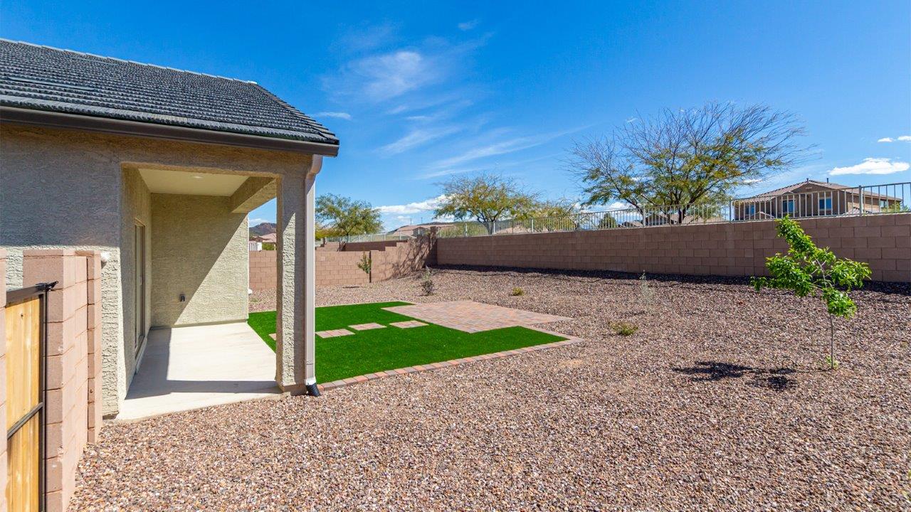 Welcome to the Kingston floor plan in the Agave neighborhood at Saguaro Bloom, Marana, Arizona—a perfect blend of comfort, modern living, and energy efficiency. This thoughtfully crafted one-story home spans 2,051 square feet and offers four bedrooms and two bathrooms, ideal for families of all sizes.  The open-concept design features a spacious great room that effortlessly connects with the kitchen and dining area, creating an inviting central hub for everyday living and entertaining. The kitchen is equipped with contemporary appliances and a pantry.  The primary bedroom, located at the rear of the home, provides a peaceful retreat with a private ensuite bathroom and a walk-in closet. The additional three bedrooms are positioned at the front of the house, offering versatility for use as guest rooms, a home office, or children’s bedrooms. Step outside to the covered patio, a perfect spot to enjoy the beautiful Arizona weather.  Built with energy efficiency as a priority, the Kingston includes smart home technology, which not only simplifies daily living but also helps reduce utility costs. A two-car garage provides ample parking and additional storage space, enhancing the home’s functionality.  Residents of Saguaro Bloom enjoy access to a range of community amenities, including parks, walking trails, and recreational facilities, making this home an ideal choice for those seeking a balanced lifestyle in a scenic setting.