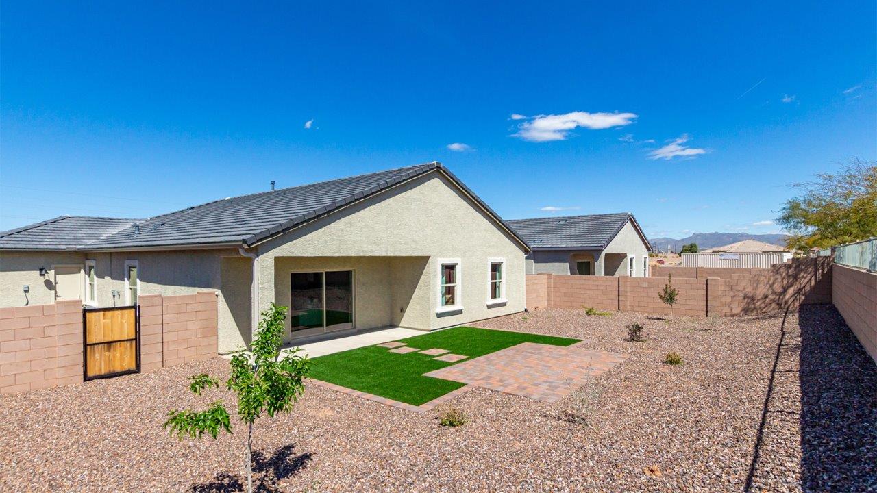 Welcome to the Kingston floor plan in the Agave neighborhood at Saguaro Bloom, Marana, Arizona—a perfect blend of comfort, modern living, and energy efficiency. This thoughtfully crafted one-story home spans 2,051 square feet and offers four bedrooms and two bathrooms, ideal for families of all sizes.  The open-concept design features a spacious great room that effortlessly connects with the kitchen and dining area, creating an inviting central hub for everyday living and entertaining. The kitchen is equipped with contemporary appliances and a pantry.  The primary bedroom, located at the rear of the home, provides a peaceful retreat with a private ensuite bathroom and a walk-in closet. The additional three bedrooms are positioned at the front of the house, offering versatility for use as guest rooms, a home office, or children’s bedrooms. Step outside to the covered patio, a perfect spot to enjoy the beautiful Arizona weather.  Built with energy efficiency as a priority, the Kingston includes smart home technology, which not only simplifies daily living but also helps reduce utility costs. A two-car garage provides ample parking and additional storage space, enhancing the home’s functionality.  Residents of Saguaro Bloom enjoy access to a range of community amenities, including parks, walking trails, and recreational facilities, making this home an ideal choice for those seeking a balanced lifestyle in a scenic setting.