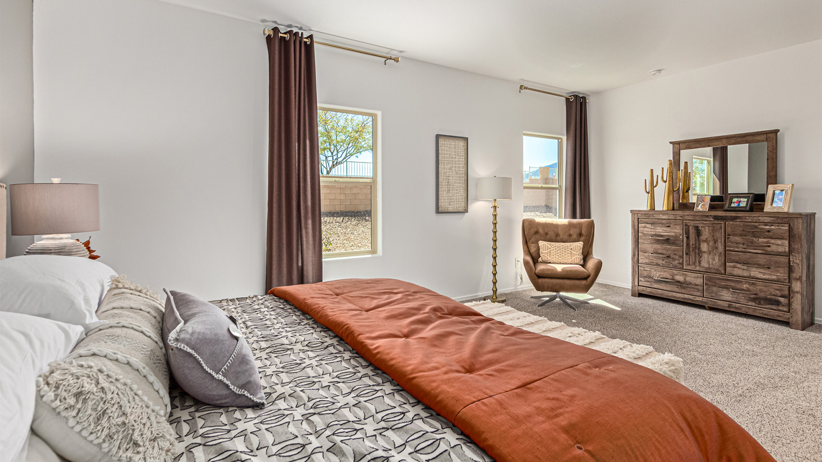 Welcome to the Kingston floor plan in the Agave neighborhood at Saguaro Bloom, Marana, Arizona—a perfect blend of comfort, modern living, and energy efficiency. This thoughtfully crafted one-story home spans 2,051 square feet and offers four bedrooms and two bathrooms, ideal for families of all sizes.  The open-concept design features a spacious great room that effortlessly connects with the kitchen and dining area, creating an inviting central hub for everyday living and entertaining. The kitchen is equipped with contemporary appliances and a pantry.  The primary bedroom, located at the rear of the home, provides a peaceful retreat with a private ensuite bathroom and a walk-in closet. The additional three bedrooms are positioned at the front of the house, offering versatility for use as guest rooms, a home office, or children’s bedrooms. Step outside to the covered patio, a perfect spot to enjoy the beautiful Arizona weather.  Built with energy efficiency as a priority, the Kingston includes smart home technology, which not only simplifies daily living but also helps reduce utility costs. A two-car garage provides ample parking and additional storage space, enhancing the home’s functionality.  Residents of Saguaro Bloom enjoy access to a range of community amenities, including parks, walking trails, and recreational facilities, making this home an ideal choice for those seeking a balanced lifestyle in a scenic setting.