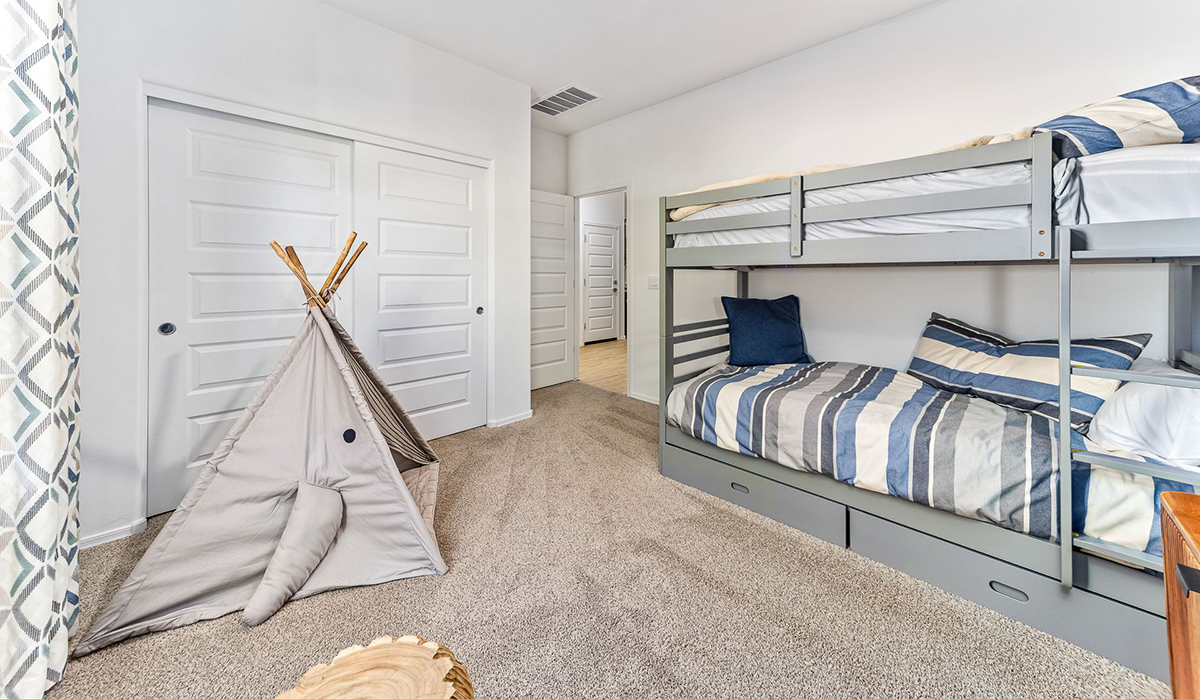 Welcome to the Kingston floor plan in the Agave neighborhood at Saguaro Bloom, Marana, Arizona—a perfect blend of comfort, modern living, and energy efficiency. This thoughtfully crafted one-story home spans 2,051 square feet and offers four bedrooms and two bathrooms, ideal for families of all sizes.  The open-concept design features a spacious great room that effortlessly connects with the kitchen and dining area, creating an inviting central hub for everyday living and entertaining. The kitchen is equipped with contemporary appliances and a pantry.  The primary bedroom, located at the rear of the home, provides a peaceful retreat with a private ensuite bathroom and a walk-in closet. The additional three bedrooms are positioned at the front of the house, offering versatility for use as guest rooms, a home office, or children’s bedrooms. Step outside to the covered patio, a perfect spot to enjoy the beautiful Arizona weather.  Built with energy efficiency as a priority, the Kingston includes smart home technology, which not only simplifies daily living but also helps reduce utility costs. A two-car garage provides ample parking and additional storage space, enhancing the home’s functionality.  Residents of Saguaro Bloom enjoy access to a range of community amenities, including parks, walking trails, and recreational facilities, making this home an ideal choice for those seeking a balanced lifestyle in a scenic setting.  *Images shown are for reference only. They depict The Kingston sales model home and may not represent the actual home.