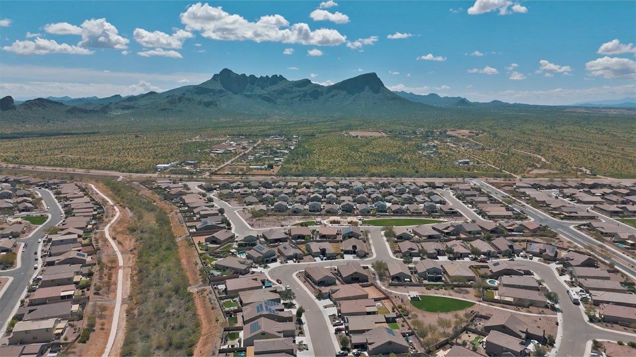 The Rosemont at Agave in Saguaro Bloom, Marana, AZ, is the largest floorplan available in this distinctive neighborhood and the only one of its kind offered throughout Tucson, Marana, Vail, and Sahuarita. This spacious two-story home spans 2,738 square feet and is designed to accommodate modern living with ample room for everyone. Featuring five bedrooms and three bathrooms, this plan offers a perfect balance of private retreats and shared spaces, ensuring comfort and functionality for families of all sizes.  Upon entering, you are welcomed by a generous great room that flows effortlessly into the dining room and kitchen, creating a cohesive space ideal for entertaining or family gatherings. The kitchen is well-equipped with stainless steel appliances, a large island with seating, and a pantry that provides abundant storage. Just off the kitchen, the covered patio offers a seamless transition to outdoor living, perfect for Arizona's mild evenings.  The first floor includes a secondary bedroom and bathroom, providing a private space for guests or an ideal home office. The primary suite, located on the ground floor, features a walk-in closet and an en suite bathroom complete with dual sinks and a spacious shower.  Upstairs, the second floor offers three additional bedrooms, each with ample closet space, and a game room or loft that can be customized to suit your lifestyle—whether it’s a playroom, media center, or home gym. A third bathroom and additional storage space round out the upstairs features, ensuring that everyone has their own space.  Standard features include quartz countertops in the kitchen and bathrooms, wood-look tile flooring in common areas, and shaker-style cabinets. The home is also equipped with the Home is Connected® Smart Home package, which includes keyless entry, a smart thermostat, a video doorbell and more, ensuring convenience and peace of mind.  The Rosemont at Agave is a unique opportunity to enjoy luxury, space, and modern conveniences in one of Marana’s most sought-after communities.