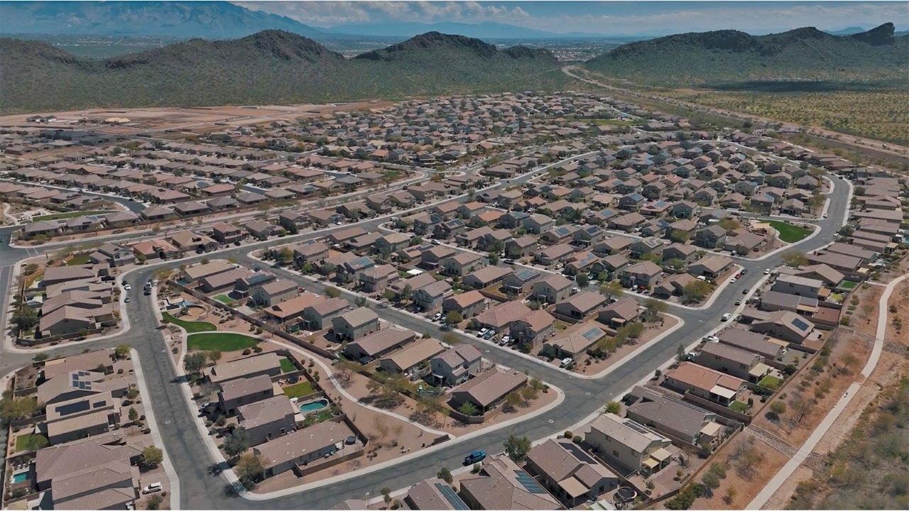 The Rosemont at Agave in Saguaro Bloom, Marana, AZ, is the largest floorplan available in this distinctive neighborhood and the only one of its kind offered throughout Tucson, Marana, Vail, and Sahuarita. This spacious two-story home spans 2,738 square feet and is designed to accommodate modern living with ample room for everyone. Featuring five bedrooms and three bathrooms, this plan offers a perfect balance of private retreats and shared spaces, ensuring comfort and functionality for families of all sizes.  Upon entering, you are welcomed by a generous great room that flows effortlessly into the dining room and kitchen, creating a cohesive space ideal for entertaining or family gatherings. The kitchen is well-equipped with stainless steel appliances, a large island with seating, and a pantry that provides abundant storage. Just off the kitchen, the covered patio offers a seamless transition to outdoor living, perfect for Arizona's mild evenings.  The first floor includes a secondary bedroom and bathroom, providing a private space for guests or an ideal home office. The primary suite, located on the ground floor, features a walk-in closet and an en suite bathroom complete with dual sinks and a spacious shower.  Upstairs, the second floor offers three additional bedrooms, each with ample closet space, and a game room or loft that can be customized to suit your lifestyle—whether it’s a playroom, media center, or home gym. A third bathroom and additional storage space round out the upstairs features, ensuring that everyone has their own space.  Standard features include quartz countertops in the kitchen and bathrooms, wood-look tile flooring in common areas, and shaker-style cabinets. The home is also equipped with the Home is Connected® Smart Home package, which includes keyless entry, a smart thermostat, a video doorbell and more, ensuring convenience and peace of mind.  The Rosemont at Agave is a unique opportunity to enjoy luxury, space, and modern conveniences in one of Marana’s most sought-after communities.