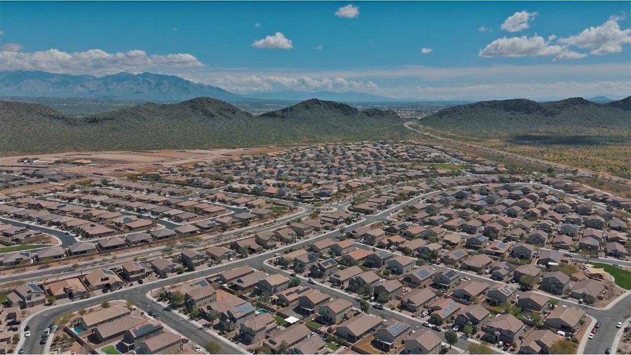 The Rosemont at Agave in Saguaro Bloom, Marana, AZ, is the largest floorplan available in this distinctive neighborhood and the only one of its kind offered throughout Tucson, Marana, Vail, and Sahuarita. This spacious two-story home spans 2,738 square feet and is designed to accommodate modern living with ample room for everyone. Featuring five bedrooms and three bathrooms, this plan offers a perfect balance of private retreats and shared spaces, ensuring comfort and functionality for families of all sizes.  Upon entering, you are welcomed by a generous great room that flows effortlessly into the dining room and kitchen, creating a cohesive space ideal for entertaining or family gatherings. The kitchen is well-equipped with stainless steel appliances, a large island with seating, and a pantry that provides abundant storage. Just off the kitchen, the covered patio offers a seamless transition to outdoor living, perfect for Arizona's mild evenings.  The first floor includes a secondary bedroom and bathroom, providing a private space for guests or an ideal home office. The primary suite, located on the ground floor, features a walk-in closet and an en suite bathroom complete with dual sinks and a spacious shower.  Upstairs, the second floor offers three additional bedrooms, each with ample closet space, and a game room or loft that can be customized to suit your lifestyle—whether it’s a playroom, media center, or home gym. A third bathroom and additional storage space round out the upstairs features, ensuring that everyone has their own space.  Standard features include quartz countertops in the kitchen and bathrooms, wood-look tile flooring in common areas, and shaker-style cabinets. The home is also equipped with the Home is Connected® Smart Home package, which includes keyless entry, a smart thermostat, a video doorbell and more, ensuring convenience and peace of mind.  The Rosemont at Agave is a unique opportunity to enjoy luxury, space, and modern conveniences in one of Marana’s most sought-after communities.