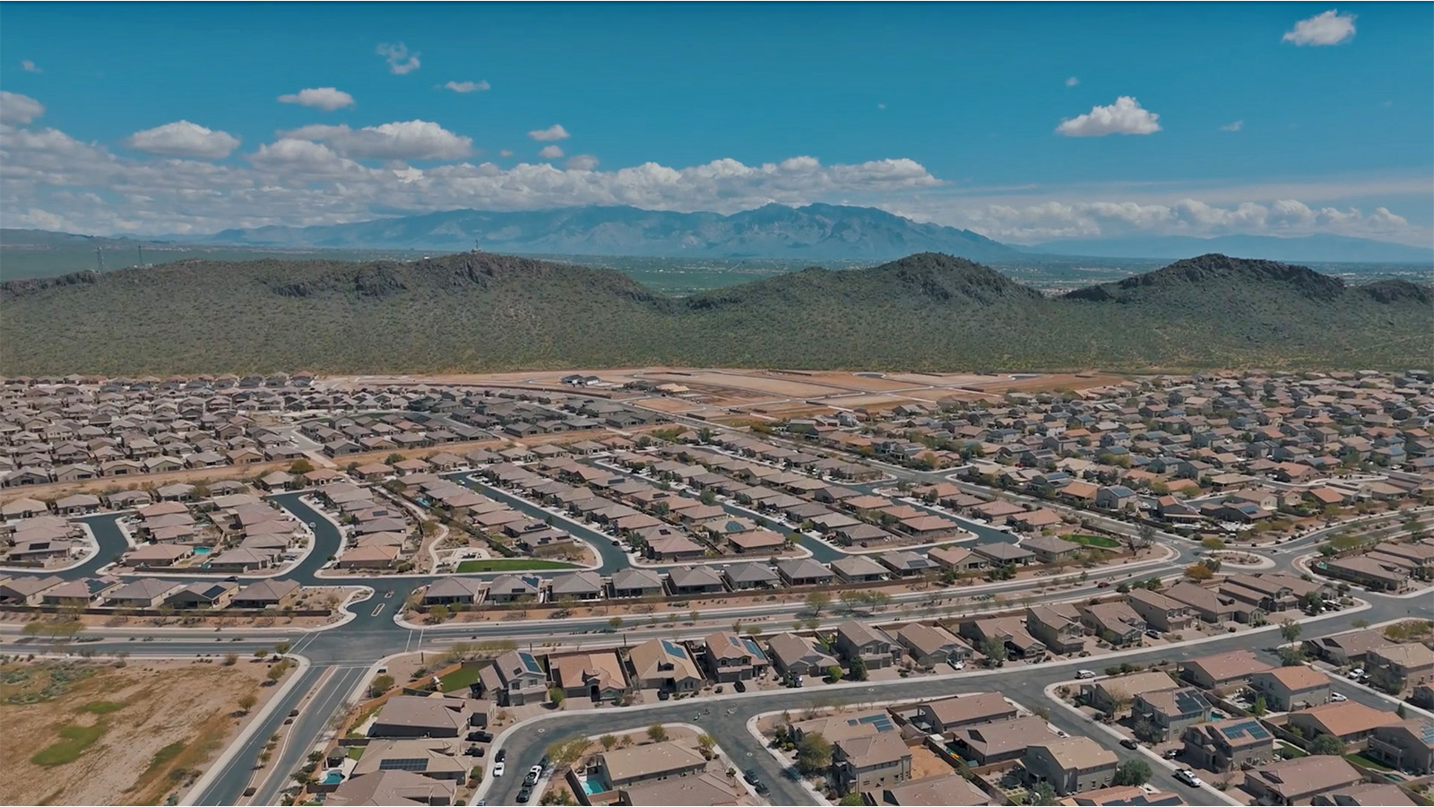 The Rosemont at Agave in Saguaro Bloom, Marana, AZ, is the largest floorplan available in this distinctive neighborhood and the only one of its kind offered throughout Tucson, Marana, Vail, and Sahuarita. This spacious two-story home spans 2,738 square feet and is designed to accommodate modern living with ample room for everyone. Featuring five bedrooms and three bathrooms, this plan offers a perfect balance of private retreats and shared spaces, ensuring comfort and functionality for families of all sizes.  Upon entering, you are welcomed by a generous great room that flows effortlessly into the dining room and kitchen, creating a cohesive space ideal for entertaining or family gatherings. The kitchen is well-equipped with stainless steel appliances, a large island with seating, and a pantry that provides abundant storage. Just off the kitchen, the covered patio offers a seamless transition to outdoor living, perfect for Arizona's mild evenings.  The first floor includes a secondary bedroom and bathroom, providing a private space for guests or an ideal home office. The primary suite, located on the ground floor, features a walk-in closet and an en suite bathroom complete with dual sinks and a spacious shower.  Upstairs, the second floor offers three additional bedrooms, each with ample closet space, and a game room or loft that can be customized to suit your lifestyle—whether it’s a playroom, media center, or home gym. A third bathroom and additional storage space round out the upstairs features, ensuring that everyone has their own space.  Standard features include quartz countertops in the kitchen and bathrooms, wood-look tile flooring in common areas, and shaker-style cabinets. The home is also equipped with the Home is Connected® Smart Home package, which includes keyless entry, a smart thermostat, a video doorbell and more, ensuring convenience and peace of mind.  The Rosemont at Agave is a unique opportunity to enjoy luxury, space, and modern conveniences in one of Marana’s most sought-after communities.