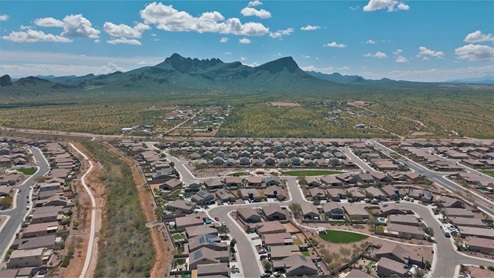 Explore New Homes at Saguaro Bloom by D.R. Horton – A Master-Planned Community in Marana, AZ. Nestled in the foothills of the breathtaking Tucson Mountains, Saguaro Bloom by D.R. Horton is a premier master-planned community in Northwest Marana that offers an exceptional living experience. Saguaro Bloom is divided into distinct neighborhoods, each offering its unique charm and amenities. *Mesquite at Saguaro Bloom* is located in Block 1 and offers a variety of spacious floorplans with 18x18 tile flooring, granite countertops in kitchen and bathrooms, and Shaker-style cabinets in white or gray. These homes feature 9’ ceilings on the first floor, island kitchens, and the Home is Connected® Smart Home package, making them perfect for modern living. *Agave at Saguaro Bloom*, situated in Block 7C, features homes with stunning 6x36” wood-look tile in gray, quartz countertops in kitchen and bathrooms, and Shaker-style cabinets. These homes are designed with stylish interiors and modern conveniences, including LED disc lighting and energy-efficient tankless water heaters. *Cholla Ridge at Saguaro Bloom*, located in Block 7B, offers single-story homes on lots with no rear neighbors. These homes are distinguished by beautiful 12x24” tile flooring, gourmet kitchens, and 10’ ceilings in select homes. With 8’ sliding glass patio doors and super showers, Cholla Ridge combines luxury and privacy in a serene setting. All homes in Saguaro Bloom are built with a Spanish lace stucco exterior, tile roofs, landscaped front yards with auto drip irrigation, and large, fully fenced backyards ready for your design. The homes also include covered front porches and back patios, stainless steel gas appliances, and executive height vanities in all bathrooms. Additionally, as of August 2024, all homes starting production are Zero Energy Ready, meeting rigorous energy efficiency standards that significantly reduce energy costs and environmental impact. Residents of Saguaro Bloom enjoy an array of community amenities, including a clubhouse, two pools with lap lanes and lagoon entry, a fitness center, a splash pad, and over 30 miles of walking trails. The community also features more than 20 pocket parks, playgrounds, and coming soon, a large community park with tennis, pickleball, soccer, baseball, and a dog park. Saguaro Bloom is truly a lifestyle community, offering regular events like Food Truck Thursdays, Movies at the Pool, and holiday decorating contests, all fostering a strong sense of community. Located in the highly-rated Marana Unified School District, Saguaro Bloom is close to excellent schools, including Rattlesnake Ridge Elementary, Marana Middle School, and Marana High School. The community’s location offers a perfect balance of seclusion and convenience, with quick access to I-10, grocery stores, restaurants, and the Twin Peaks Outlet, all within minutes. Downtown Tucson, with its vibrant arts, culture, and entertainment scene, is just a short 15-minute drive away. Surrounded by the natural beauty of the desert landscape, residents can explore nearby outdoor attractions like Saguaro National Park West, the Arizona Desert Museum, and Quarry Pines Golf Course. Whether you enjoy hiking, biking, or simply taking in the stunning views, Saguaro Bloom offers an unparalleled lifestyle in one of Arizona’s most sought-after locations. Discover the perfect blend of modern amenities, scenic beauty, and a strong sense of community at Saguaro Bloom by D.R. Horton – where your new home awaits in Marana, AZ.