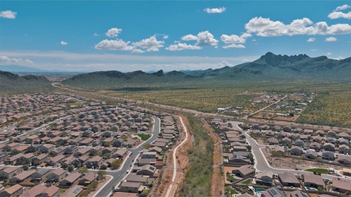 Explore New Homes at Saguaro Bloom by D.R. Horton – A Master-Planned Community in Marana, AZ. Nestled in the foothills of the breathtaking Tucson Mountains, Saguaro Bloom by D.R. Horton is a premier master-planned community in Northwest Marana that offers an exceptional living experience. Saguaro Bloom is divided into distinct neighborhoods, each offering its unique charm and amenities. *Mesquite at Saguaro Bloom* is located in Block 1 and offers a variety of spacious floorplans with 18x18 tile flooring, granite countertops in kitchen and bathrooms, and Shaker-style cabinets in white or gray. These homes feature 9’ ceilings on the first floor, island kitchens, and the Home is Connected® Smart Home package, making them perfect for modern living. *Agave at Saguaro Bloom*, situated in Block 7C, features homes with stunning 6x36” wood-look tile in gray, quartz countertops in kitchen and bathrooms, and Shaker-style cabinets. These homes are designed with stylish interiors and modern conveniences, including LED disc lighting and energy-efficient tankless water heaters. *Cholla Ridge at Saguaro Bloom*, located in Block 7B, offers single-story homes on lots with no rear neighbors. These homes are distinguished by beautiful 12x24” tile flooring, gourmet kitchens, and 10’ ceilings in select homes. With 8’ sliding glass patio doors and super showers, Cholla Ridge combines luxury and privacy in a serene setting. All homes in Saguaro Bloom are built with a Spanish lace stucco exterior, tile roofs, landscaped front yards with auto drip irrigation, and large, fully fenced backyards ready for your design. The homes also include covered front porches and back patios, stainless steel gas appliances, and executive height vanities in all bathrooms. Additionally, as of August 2024, all homes starting production are Zero Energy Ready, meeting rigorous energy efficiency standards that significantly reduce energy costs and environmental impact. Residents of Saguaro Bloom enjoy an array of community amenities, including a clubhouse, two pools with lap lanes and lagoon entry, a fitness center, a splash pad, and over 30 miles of walking trails. The community also features more than 20 pocket parks, playgrounds, and coming soon, a large community park with tennis, pickleball, soccer, baseball, and a dog park. Saguaro Bloom is truly a lifestyle community, offering regular events like Food Truck Thursdays, Movies at the Pool, and holiday decorating contests, all fostering a strong sense of community. Located in the highly-rated Marana Unified School District, Saguaro Bloom is close to excellent schools, including Rattlesnake Ridge Elementary, Marana Middle School, and Marana High School. The community’s location offers a perfect balance of seclusion and convenience, with quick access to I-10, grocery stores, restaurants, and the Twin Peaks Outlet, all within minutes. Downtown Tucson, with its vibrant arts, culture, and entertainment scene, is just a short 15-minute drive away. Surrounded by the natural beauty of the desert landscape, residents can explore nearby outdoor attractions like Saguaro National Park West, the Arizona Desert Museum, and Quarry Pines Golf Course. Whether you enjoy hiking, biking, or simply taking in the stunning views, Saguaro Bloom offers an unparalleled lifestyle in one of Arizona’s most sought-after locations. Discover the perfect blend of modern amenities, scenic beauty, and a strong sense of community at Saguaro Bloom by D.R. Horton – where your new home awaits in Marana, AZ.