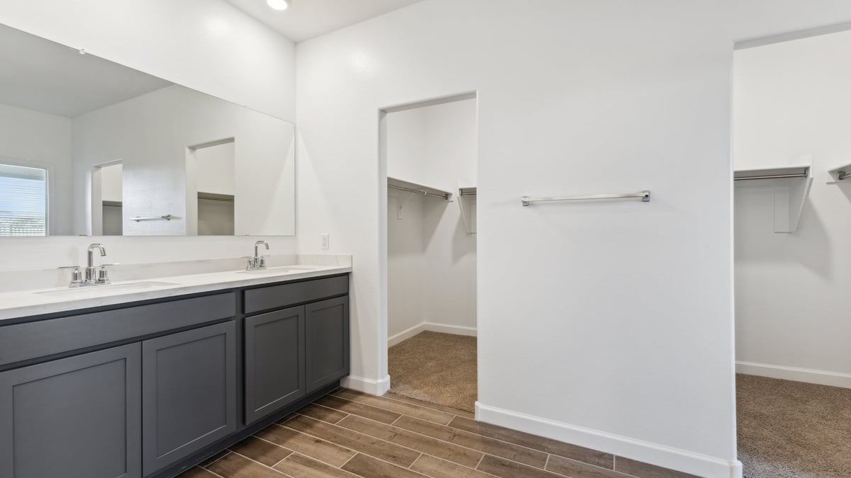 The Garland is a spacious single-story new home situated in the Agave neighborhood at Saguaro Bloom, offering 2,273 square feet of well-planned living. This home features four bedrooms and three full bathrooms making it an ideal choice for families and those needing room to grow.  As you enter through the porch and into the front door, you're greeted by the open concept layout with a seamless flow between the living, dining, and kitchen area. The kitchen features a large central island, quartz countertops, and your choice of flat panel Shaker-style cabinet doors with multiple color options available. A walk-in pantry provides additional storage, making it easy to keep everything organized.  The Garland's four bedrooms are thoughtfully arranged to provide both privacy and convenience. The primary suite is tucked away at the rear of the home, offering a private retreat with walk-in closets off the en-suite bathroom complete with an optional dual sink vanity. The additional bedrooms are strategically placed near the front and center of the home, each with access to a full bathroom, ensuring comfort for all family members or guests.  The large great room serves as the central gathering space, perfect for family activities or entertaining guests. Adjacent to the great room is a covered patio, extending your living space outdoors and offering a perfect spot to enjoy the serene surroundings of Saguaro Bloom.  Practical features like a dedicated utility room and a spacious three-car garage enhance the functionality of this home, while large windows ensure that natural light fills the space, creating a bright and inviting atmosphere.  Located within the vibrant Saguaro Bloom community, residents of The Garland can take advantage of a wide array of amenities, from resort-style pools to extensive walking trails. This home offers a unique opportunity to enjoy both comfort and community in one of Marana’s most sought-after neighborhoods.  *Images shown are for reference only. They depict a Garland home and may not represent the actual home or design package.