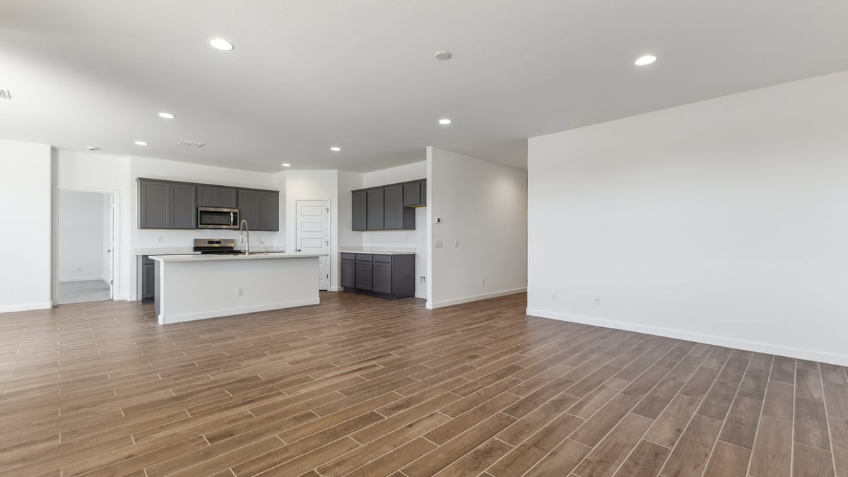 The Garland is a spacious single-story new home situated in the Agave neighborhood at Saguaro Bloom, offering 2,273 square feet of well-planned living. This home features four bedrooms and three full bathrooms making it an ideal choice for families and those needing room to grow.  As you enter through the porch and into the front door, you're greeted by the open concept layout with a seamless flow between the living, dining, and kitchen area. The kitchen features a large central island, quartz countertops, and your choice of flat panel Shaker-style cabinet doors with multiple color options available. A walk-in pantry provides additional storage, making it easy to keep everything organized.  The Garland's four bedrooms are thoughtfully arranged to provide both privacy and convenience. The primary suite is tucked away at the rear of the home, offering a private retreat with walk-in closets off the en-suite bathroom complete with an optional dual sink vanity. The additional bedrooms are strategically placed near the front and center of the home, each with access to a full bathroom, ensuring comfort for all family members or guests.  The large great room serves as the central gathering space, perfect for family activities or entertaining guests. Adjacent to the great room is a covered patio, extending your living space outdoors and offering a perfect spot to enjoy the serene surroundings of Saguaro Bloom.  Practical features like a dedicated utility room and a spacious three-car garage enhance the functionality of this home, while large windows ensure that natural light fills the space, creating a bright and inviting atmosphere.  Located within the vibrant Saguaro Bloom community, residents of The Garland can take advantage of a wide array of amenities, from resort-style pools to extensive walking trails. This home offers a unique opportunity to enjoy both comfort and community in one of Marana’s most sought-after neighborhoods.  *Images shown are for reference only. They depict a Garland home and may not represent the actual home or design package.