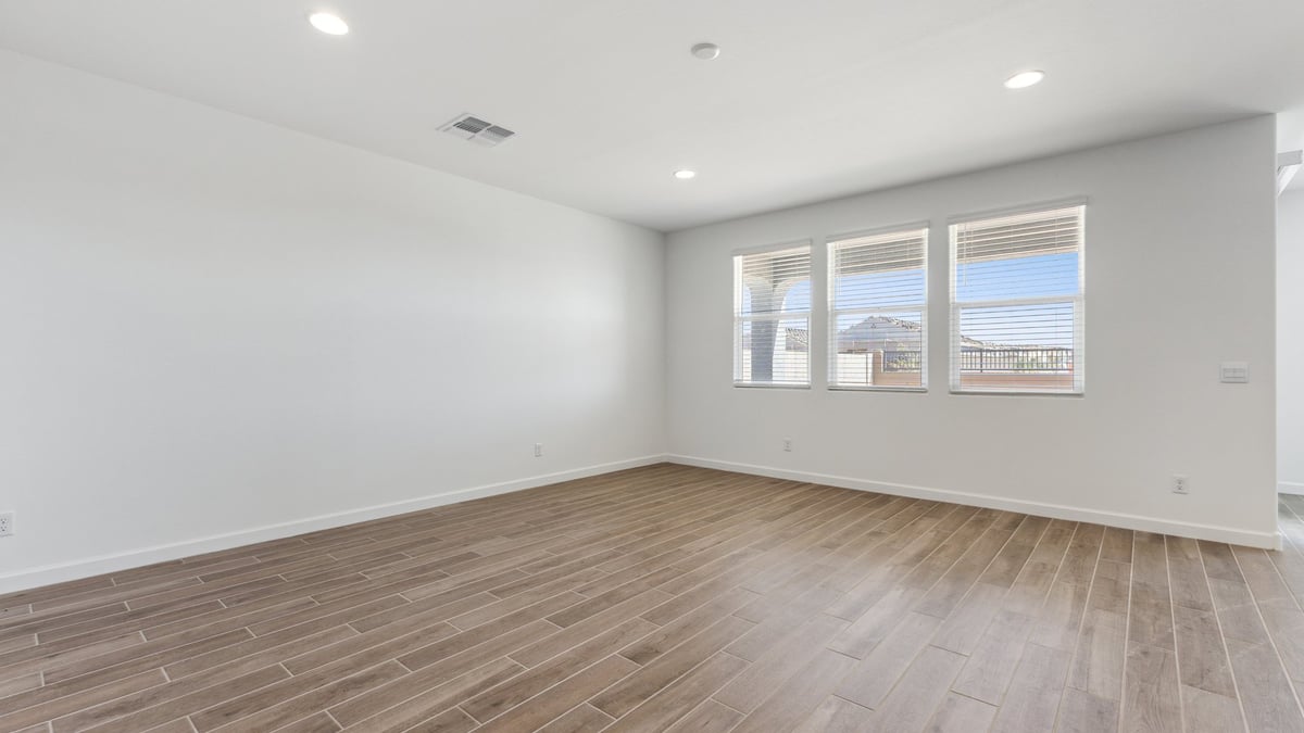 The Garland floor plan is a spacious single-story new home situated in the Agave neighborhood at Saguaro Bloom, offering 2,273 square feet of well-planned living space that perfectly suits a variety of lifestyles. This home features four bedrooms and three full bathrooms making it an ideal choice for families and those needing room to grow. As you step into the front porch and through the front door, you're greeted by the open concept layout with a seamless flow between the living, dining, and kitchen area, ensuring that every part of the home feels connected. The kitchen, equipped with a central island, quartz countertops, and your choice of flat panel Shaker-style cabinet doors with multiple color options available. A walk-in pantry provides additional storage, making it easy to keep everything organized.  The Garland's four bedrooms are thoughtfully arranged to provide both privacy and convenience. The primary suite is tucked away at the rear of the home, offering a private retreat with walk-in closets off the en-suite bathroom complete with an optional dual sink vanity. The additional bedrooms are strategically placed near the front and center of the home, each with access to a full bathroom, ensuring comfort for all family members or guests.  The large great room serves as the central gathering space, perfect for family activities or entertaining guests. Adjacent to the great room is a covered patio, extending your living space outdoors and offering a perfect spot to enjoy the serene surroundings of Saguaro Bloom.  Practical features like a dedicated utility room and a spacious three-car garage enhance the functionality of this home, while large windows ensure that natural light fills the space, creating a bright and inviting atmosphere.  Located within the vibrant Saguaro Bloom community, residents of The Garland can take advantage of a wide array of amenities, from resort-style pools to extensive walking trails. This home offers a unique opportunity to enjoy both comfort and community in one of Marana’s most sought-after neighborhoods.