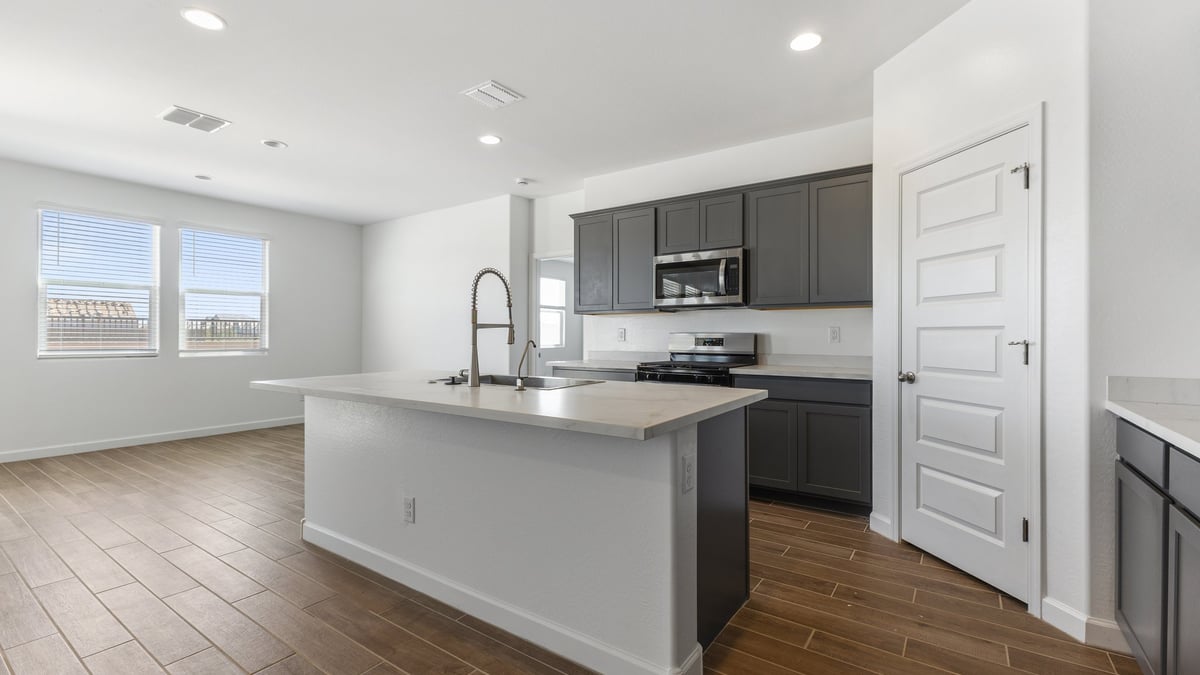 The Garland floor plan is a spacious single-story new home situated in the Agave neighborhood at Saguaro Bloom, offering 2,273 square feet of well-planned living space that perfectly suits a variety of lifestyles. This home features four bedrooms and three full bathrooms making it an ideal choice for families and those needing room to grow. As you step into the front porch and through the front door, you're greeted by the open concept layout with a seamless flow between the living, dining, and kitchen area, ensuring that every part of the home feels connected. The kitchen, equipped with a central island, quartz countertops, and your choice of flat panel Shaker-style cabinet doors with multiple color options available. A walk-in pantry provides additional storage, making it easy to keep everything organized.  The Garland's four bedrooms are thoughtfully arranged to provide both privacy and convenience. The primary suite is tucked away at the rear of the home, offering a private retreat with walk-in closets off the en-suite bathroom complete with an optional dual sink vanity. The additional bedrooms are strategically placed near the front and center of the home, each with access to a full bathroom, ensuring comfort for all family members or guests.  The large great room serves as the central gathering space, perfect for family activities or entertaining guests. Adjacent to the great room is a covered patio, extending your living space outdoors and offering a perfect spot to enjoy the serene surroundings of Saguaro Bloom.  Practical features like a dedicated utility room and a spacious three-car garage enhance the functionality of this home, while large windows ensure that natural light fills the space, creating a bright and inviting atmosphere.  Located within the vibrant Saguaro Bloom community, residents of The Garland can take advantage of a wide array of amenities, from resort-style pools to extensive walking trails. This home offers a unique opportunity to enjoy both comfort and community in one of Marana’s most sought-after neighborhoods.