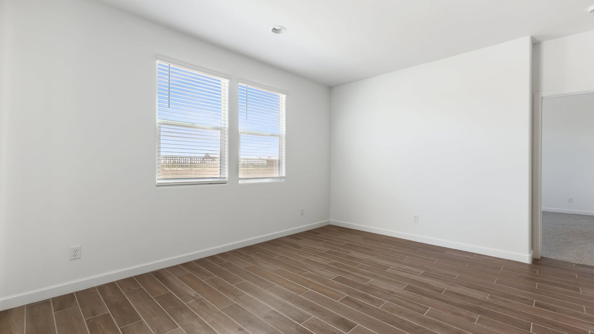 The Garland floor plan is a spacious single-story new home situated in the Agave neighborhood at Saguaro Bloom, offering 2,273 square feet of well-planned living space that perfectly suits a variety of lifestyles. This home features four bedrooms and three full bathrooms making it an ideal choice for families and those needing room to grow. As you step into the front porch and through the front door, you're greeted by the open concept layout with a seamless flow between the living, dining, and kitchen area, ensuring that every part of the home feels connected. The kitchen, equipped with a central island, quartz countertops, and your choice of flat panel Shaker-style cabinet doors with multiple color options available. A walk-in pantry provides additional storage, making it easy to keep everything organized.  The Garland's four bedrooms are thoughtfully arranged to provide both privacy and convenience. The primary suite is tucked away at the rear of the home, offering a private retreat with walk-in closets off the en-suite bathroom complete with an optional dual sink vanity. The additional bedrooms are strategically placed near the front and center of the home, each with access to a full bathroom, ensuring comfort for all family members or guests.  The large great room serves as the central gathering space, perfect for family activities or entertaining guests. Adjacent to the great room is a covered patio, extending your living space outdoors and offering a perfect spot to enjoy the serene surroundings of Saguaro Bloom.  Practical features like a dedicated utility room and a spacious three-car garage enhance the functionality of this home, while large windows ensure that natural light fills the space, creating a bright and inviting atmosphere.  Located within the vibrant Saguaro Bloom community, residents of The Garland can take advantage of a wide array of amenities, from resort-style pools to extensive walking trails. This home offers a unique opportunity to enjoy both comfort and community in one of Marana’s most sought-after neighborhoods.