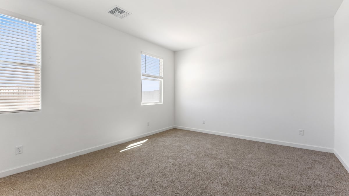 The Garland floor plan is a spacious single-story new home situated in the Agave neighborhood at Saguaro Bloom, offering 2,273 square feet of well-planned living space that perfectly suits a variety of lifestyles. This home features four bedrooms and three full bathrooms making it an ideal choice for families and those needing room to grow. As you step into the front porch and through the front door, you're greeted by the open concept layout with a seamless flow between the living, dining, and kitchen area, ensuring that every part of the home feels connected. The kitchen, equipped with a central island, quartz countertops, and your choice of flat panel Shaker-style cabinet doors with multiple color options available. A walk-in pantry provides additional storage, making it easy to keep everything organized.  The Garland's four bedrooms are thoughtfully arranged to provide both privacy and convenience. The primary suite is tucked away at the rear of the home, offering a private retreat with walk-in closets off the en-suite bathroom complete with an optional dual sink vanity. The additional bedrooms are strategically placed near the front and center of the home, each with access to a full bathroom, ensuring comfort for all family members or guests.  The large great room serves as the central gathering space, perfect for family activities or entertaining guests. Adjacent to the great room is a covered patio, extending your living space outdoors and offering a perfect spot to enjoy the serene surroundings of Saguaro Bloom.  Practical features like a dedicated utility room and a spacious three-car garage enhance the functionality of this home, while large windows ensure that natural light fills the space, creating a bright and inviting atmosphere.  Located within the vibrant Saguaro Bloom community, residents of The Garland can take advantage of a wide array of amenities, from resort-style pools to extensive walking trails. This home offers a unique opportunity to enjoy both comfort and community in one of Marana’s most sought-after neighborhoods.