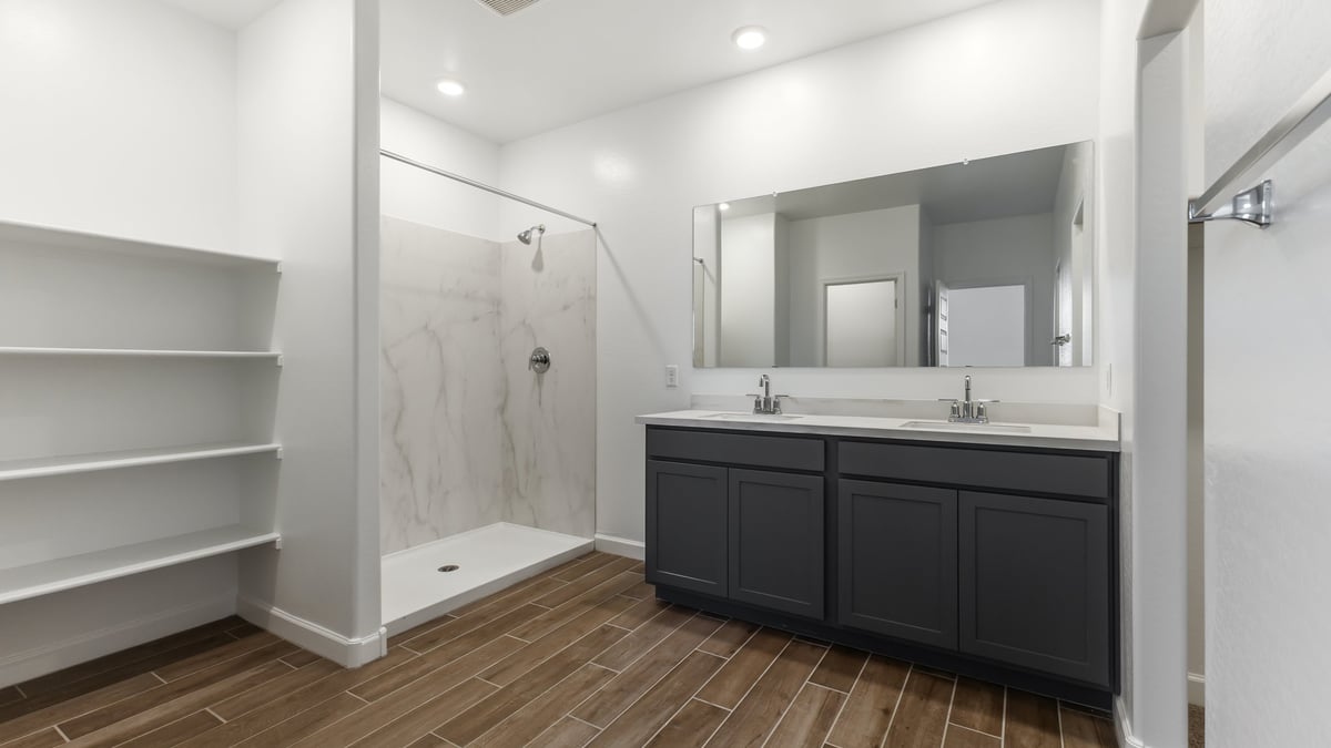 The Garland floor plan is a spacious single-story new home situated in the Agave neighborhood at Saguaro Bloom, offering 2,273 square feet of well-planned living space that perfectly suits a variety of lifestyles. This home features four bedrooms and three full bathrooms making it an ideal choice for families and those needing room to grow. As you step into the front porch and through the front door, you're greeted by the open concept layout with a seamless flow between the living, dining, and kitchen area, ensuring that every part of the home feels connected. The kitchen, equipped with a central island, quartz countertops, and your choice of flat panel Shaker-style cabinet doors with multiple color options available. A walk-in pantry provides additional storage, making it easy to keep everything organized.  The Garland's four bedrooms are thoughtfully arranged to provide both privacy and convenience. The primary suite is tucked away at the rear of the home, offering a private retreat with walk-in closets off the en-suite bathroom complete with an optional dual sink vanity. The additional bedrooms are strategically placed near the front and center of the home, each with access to a full bathroom, ensuring comfort for all family members or guests.  The large great room serves as the central gathering space, perfect for family activities or entertaining guests. Adjacent to the great room is a covered patio, extending your living space outdoors and offering a perfect spot to enjoy the serene surroundings of Saguaro Bloom.  Practical features like a dedicated utility room and a spacious three-car garage enhance the functionality of this home, while large windows ensure that natural light fills the space, creating a bright and inviting atmosphere.  Located within the vibrant Saguaro Bloom community, residents of The Garland can take advantage of a wide array of amenities, from resort-style pools to extensive walking trails. This home offers a unique opportunity to enjoy both comfort and community in one of Marana’s most sought-after neighborhoods.