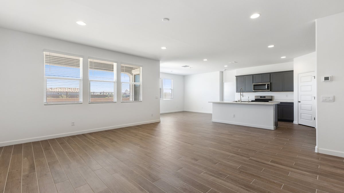 The Garland floor plan is a spacious single-story new home situated in the Agave neighborhood at Saguaro Bloom, offering 2,273 square feet of well-planned living space that perfectly suits a variety of lifestyles. This home features four bedrooms and three full bathrooms making it an ideal choice for families and those needing room to grow. As you step into the front porch and through the front door, you're greeted by the open concept layout with a seamless flow between the living, dining, and kitchen area, ensuring that every part of the home feels connected. The kitchen, equipped with a central island, quartz countertops, and your choice of flat panel Shaker-style cabinet doors with multiple color options available. A walk-in pantry provides additional storage, making it easy to keep everything organized.  The Garland's four bedrooms are thoughtfully arranged to provide both privacy and convenience. The primary suite is tucked away at the rear of the home, offering a private retreat with walk-in closets off the en-suite bathroom complete with an optional dual sink vanity. The additional bedrooms are strategically placed near the front and center of the home, each with access to a full bathroom, ensuring comfort for all family members or guests.  The large great room serves as the central gathering space, perfect for family activities or entertaining guests. Adjacent to the great room is a covered patio, extending your living space outdoors and offering a perfect spot to enjoy the serene surroundings of Saguaro Bloom.  Practical features like a dedicated utility room and a spacious three-car garage enhance the functionality of this home, while large windows ensure that natural light fills the space, creating a bright and inviting atmosphere.  Located within the vibrant Saguaro Bloom community, residents of The Garland can take advantage of a wide array of amenities, from resort-style pools to extensive walking trails. This home offers a unique opportunity to enjoy both comfort and community in one of Marana’s most sought-after neighborhoods.