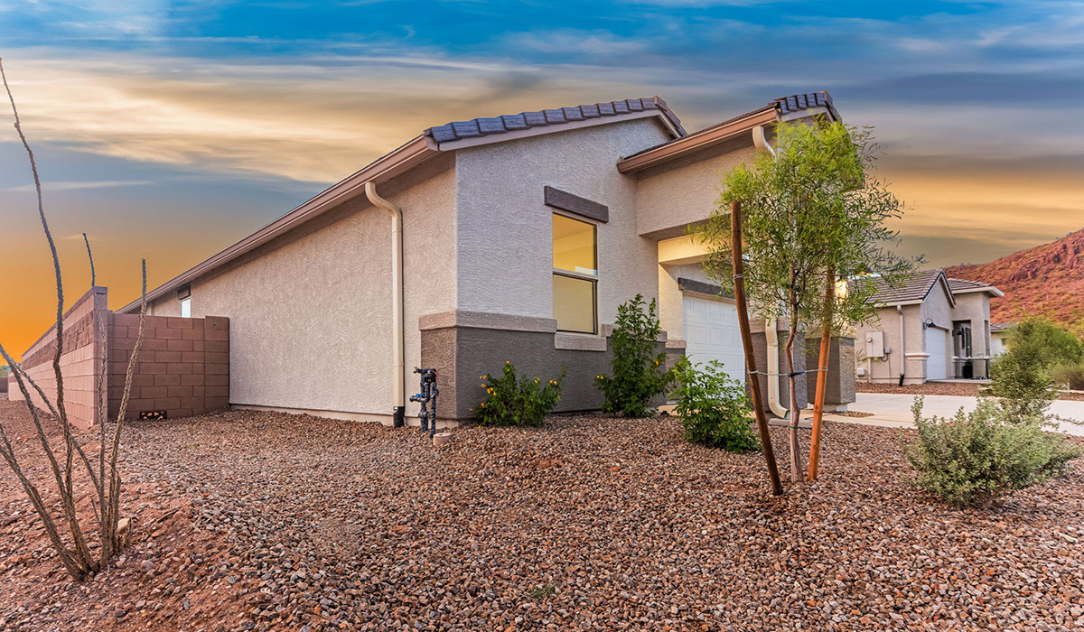 The Garland is a spacious single-story new home situated in the Agave neighborhood at Saguaro Bloom, offering 2,273 square feet of well-planned living. This home features four bedrooms and three full bathrooms making it an ideal choice for families and those needing room to grow.  As you enter through the porch and into the front door, you're greeted by the open concept layout with a seamless flow between the living, dining, and kitchen area. The kitchen features a large central island, quartz countertops, and your choice of flat panel Shaker-style cabinet doors with multiple color options available. A walk-in pantry provides additional storage, making it easy to keep everything organized.  The Garland's four bedrooms are thoughtfully arranged to provide both privacy and convenience. The primary suite is tucked away at the rear of the home, offering a private retreat with walk-in closets off the en-suite bathroom complete with an optional dual sink vanity. The additional bedrooms are strategically placed near the front and center of the home, each with access to a full bathroom, ensuring comfort for all family members or guests.  The large great room serves as the central gathering space, perfect for family activities or entertaining guests. Adjacent to the great room is a covered patio, extending your living space outdoors and offering a perfect spot to enjoy the serene surroundings of Saguaro Bloom.  Practical features like a dedicated utility room and a spacious three-car garage enhance the functionality of this home, while large windows ensure that natural light fills the space, creating a bright and inviting atmosphere.  Located within the vibrant Saguaro Bloom community, residents of The Garland can take advantage of a wide array of amenities, from resort-style pools to extensive walking trails. This home offers a unique opportunity to enjoy both comfort and community in one of Marana’s most sought-after neighborhoods.  *Images shown are for reference only. They depict The Garland spec home and may not represent the actual home.