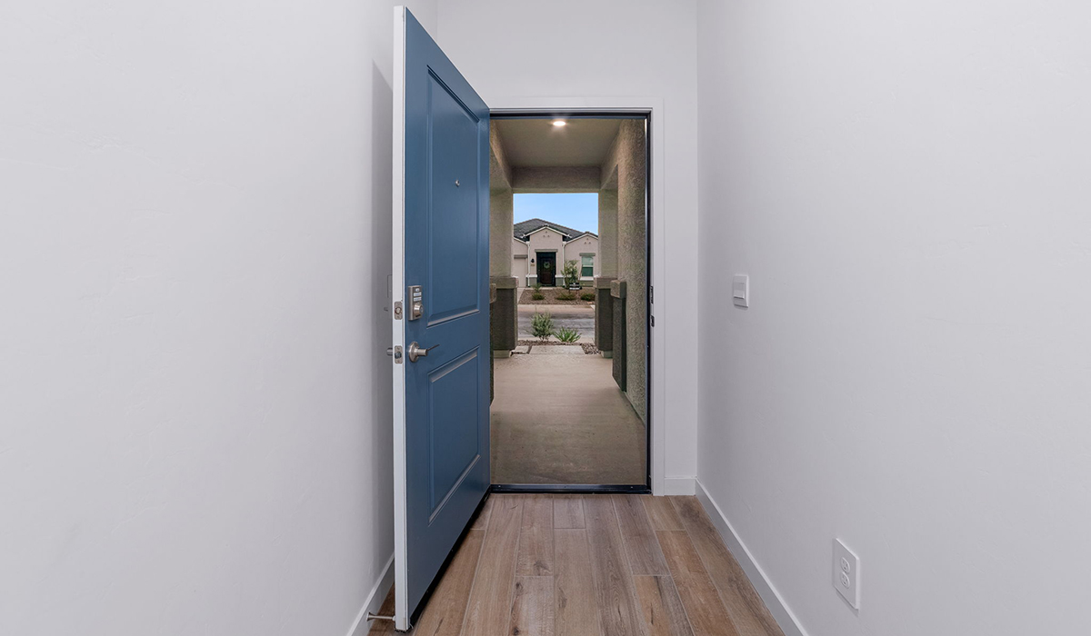 The Garland is a spacious single-story new home situated in the Agave neighborhood at Saguaro Bloom, offering 2,273 square feet of well-planned living. This home features four bedrooms and three full bathrooms making it an ideal choice for families and those needing room to grow.  As you enter through the porch and into the front door, you're greeted by the open concept layout with a seamless flow between the living, dining, and kitchen area. The kitchen features a large central island, quartz countertops, and your choice of flat panel Shaker-style cabinet doors with multiple color options available. A walk-in pantry provides additional storage, making it easy to keep everything organized.  The Garland's four bedrooms are thoughtfully arranged to provide both privacy and convenience. The primary suite is tucked away at the rear of the home, offering a private retreat with walk-in closets off the en-suite bathroom complete with an optional dual sink vanity. The additional bedrooms are strategically placed near the front and center of the home, each with access to a full bathroom, ensuring comfort for all family members or guests.  The large great room serves as the central gathering space, perfect for family activities or entertaining guests. Adjacent to the great room is a covered patio, extending your living space outdoors and offering a perfect spot to enjoy the serene surroundings of Saguaro Bloom.  Practical features like a dedicated utility room and a spacious three-car garage enhance the functionality of this home, while large windows ensure that natural light fills the space, creating a bright and inviting atmosphere.  Located within the vibrant Saguaro Bloom community, residents of The Garland can take advantage of a wide array of amenities, from resort-style pools to extensive walking trails. This home offers a unique opportunity to enjoy both comfort and community in one of Marana’s most sought-after neighborhoods.  *Images shown are for reference only. They depict The Garland spec home and may not represent the actual home.