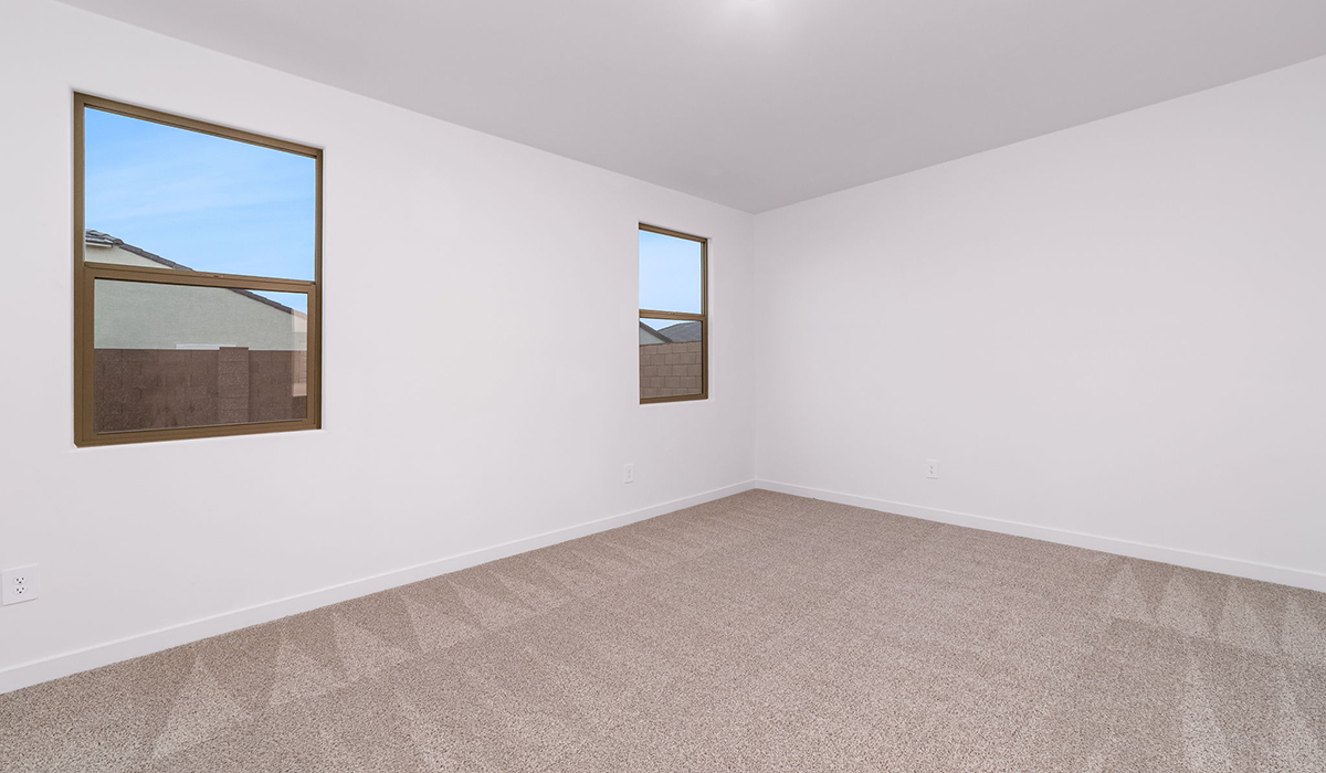 The Garland is a spacious single-story new home situated in the Agave neighborhood at Saguaro Bloom, offering 2,273 square feet of well-planned living. This home features four bedrooms and three full bathrooms making it an ideal choice for families and those needing room to grow.  As you enter through the porch and into the front door, you're greeted by the open concept layout with a seamless flow between the living, dining, and kitchen area. The kitchen features a large central island, quartz countertops, and your choice of flat panel Shaker-style cabinet doors with multiple color options available. A walk-in pantry provides additional storage, making it easy to keep everything organized.  The Garland's four bedrooms are thoughtfully arranged to provide both privacy and convenience. The primary suite is tucked away at the rear of the home, offering a private retreat with walk-in closets off the en-suite bathroom complete with an optional dual sink vanity. The additional bedrooms are strategically placed near the front and center of the home, each with access to a full bathroom, ensuring comfort for all family members or guests.  The large great room serves as the central gathering space, perfect for family activities or entertaining guests. Adjacent to the great room is a covered patio, extending your living space outdoors and offering a perfect spot to enjoy the serene surroundings of Saguaro Bloom.  Practical features like a dedicated utility room and a spacious three-car garage enhance the functionality of this home, while large windows ensure that natural light fills the space, creating a bright and inviting atmosphere.  Located within the vibrant Saguaro Bloom community, residents of The Garland can take advantage of a wide array of amenities, from resort-style pools to extensive walking trails. This home offers a unique opportunity to enjoy both comfort and community in one of Marana’s most sought-after neighborhoods.  *Images shown are for reference only. They depict the Garland floor plan and may not represent the actual home.