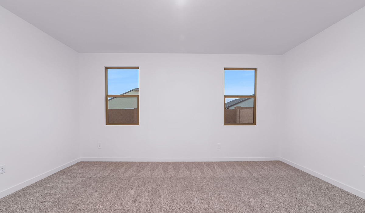 The Garland is a spacious single-story new home situated in the Agave neighborhood at Saguaro Bloom, offering 2,273 square feet of well-planned living. This home features four bedrooms and three full bathrooms making it an ideal choice for families and those needing room to grow.  As you enter through the porch and into the front door, you're greeted by the open concept layout with a seamless flow between the living, dining, and kitchen area. The kitchen features a large central island, quartz countertops, and your choice of flat panel Shaker-style cabinet doors with multiple color options available. A walk-in pantry provides additional storage, making it easy to keep everything organized.  The Garland's four bedrooms are thoughtfully arranged to provide both privacy and convenience. The primary suite is tucked away at the rear of the home, offering a private retreat with walk-in closets off the en-suite bathroom complete with an optional dual sink vanity. The additional bedrooms are strategically placed near the front and center of the home, each with access to a full bathroom, ensuring comfort for all family members or guests.  The large great room serves as the central gathering space, perfect for family activities or entertaining guests. Adjacent to the great room is a covered patio, extending your living space outdoors and offering a perfect spot to enjoy the serene surroundings of Saguaro Bloom.  Practical features like a dedicated utility room and a spacious three-car garage enhance the functionality of this home, while large windows ensure that natural light fills the space, creating a bright and inviting atmosphere.  Located within the vibrant Saguaro Bloom community, residents of The Garland can take advantage of a wide array of amenities, from resort-style pools to extensive walking trails. This home offers a unique opportunity to enjoy both comfort and community in one of Marana’s most sought-after neighborhoods.  *Images shown are for reference only. They depict the Garland floor plan and may not represent the actual home.