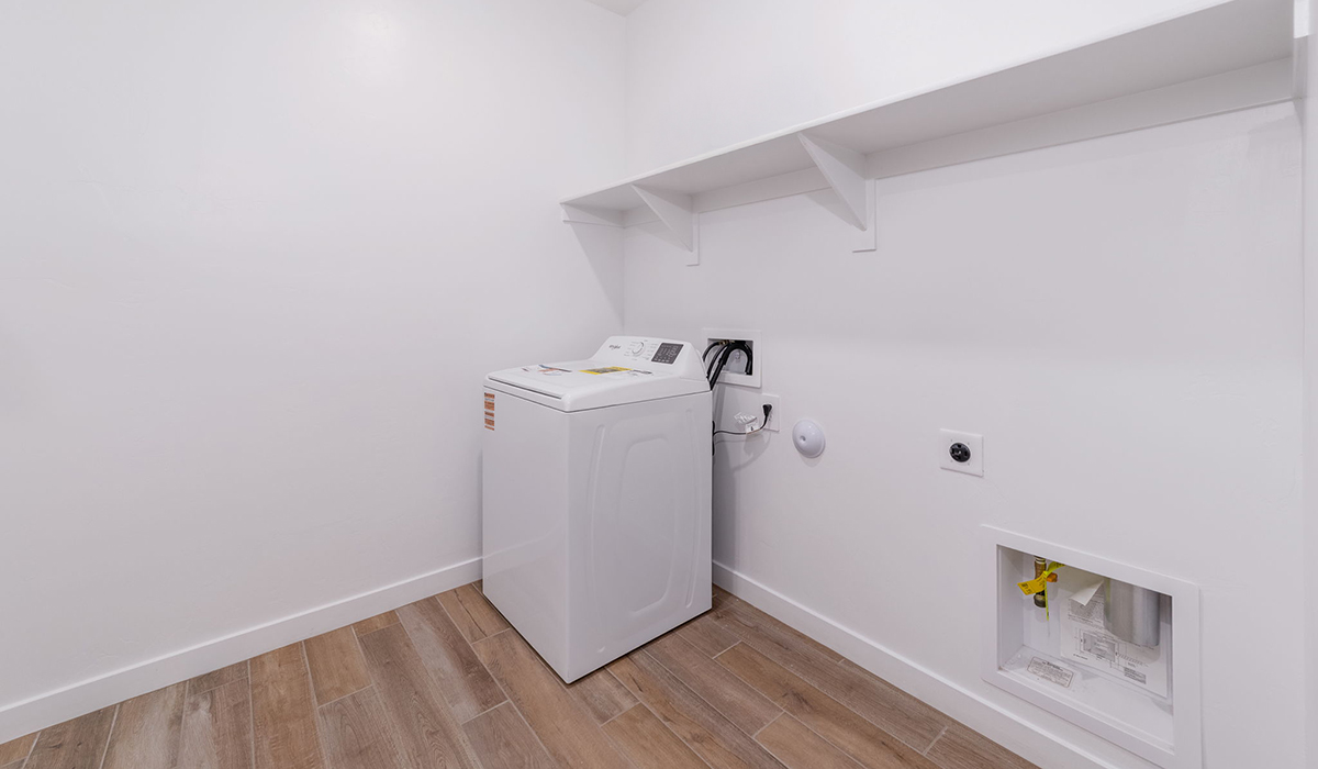 The Garland is a spacious single-story new home situated in the Agave neighborhood at Saguaro Bloom, offering 2,273 square feet of well-planned living. This home features four bedrooms and three full bathrooms making it an ideal choice for families and those needing room to grow.  As you enter through the porch and into the front door, you're greeted by the open concept layout with a seamless flow between the living, dining, and kitchen area. The kitchen features a large central island, quartz countertops, and your choice of flat panel Shaker-style cabinet doors with multiple color options available. A walk-in pantry provides additional storage, making it easy to keep everything organized.  The Garland's four bedrooms are thoughtfully arranged to provide both privacy and convenience. The primary suite is tucked away at the rear of the home, offering a private retreat with walk-in closets off the en-suite bathroom complete with an optional dual sink vanity. The additional bedrooms are strategically placed near the front and center of the home, each with access to a full bathroom, ensuring comfort for all family members or guests.  The large great room serves as the central gathering space, perfect for family activities or entertaining guests. Adjacent to the great room is a covered patio, extending your living space outdoors and offering a perfect spot to enjoy the serene surroundings of Saguaro Bloom.  Practical features like a dedicated utility room and a spacious three-car garage enhance the functionality of this home, while large windows ensure that natural light fills the space, creating a bright and inviting atmosphere.  Located within the vibrant Saguaro Bloom community, residents of The Garland can take advantage of a wide array of amenities, from resort-style pools to extensive walking trails. This home offers a unique opportunity to enjoy both comfort and community in one of Marana’s most sought-after neighborhoods.  *Images shown are for reference only. They depict the Garland floor plan and may not represent the actual home.