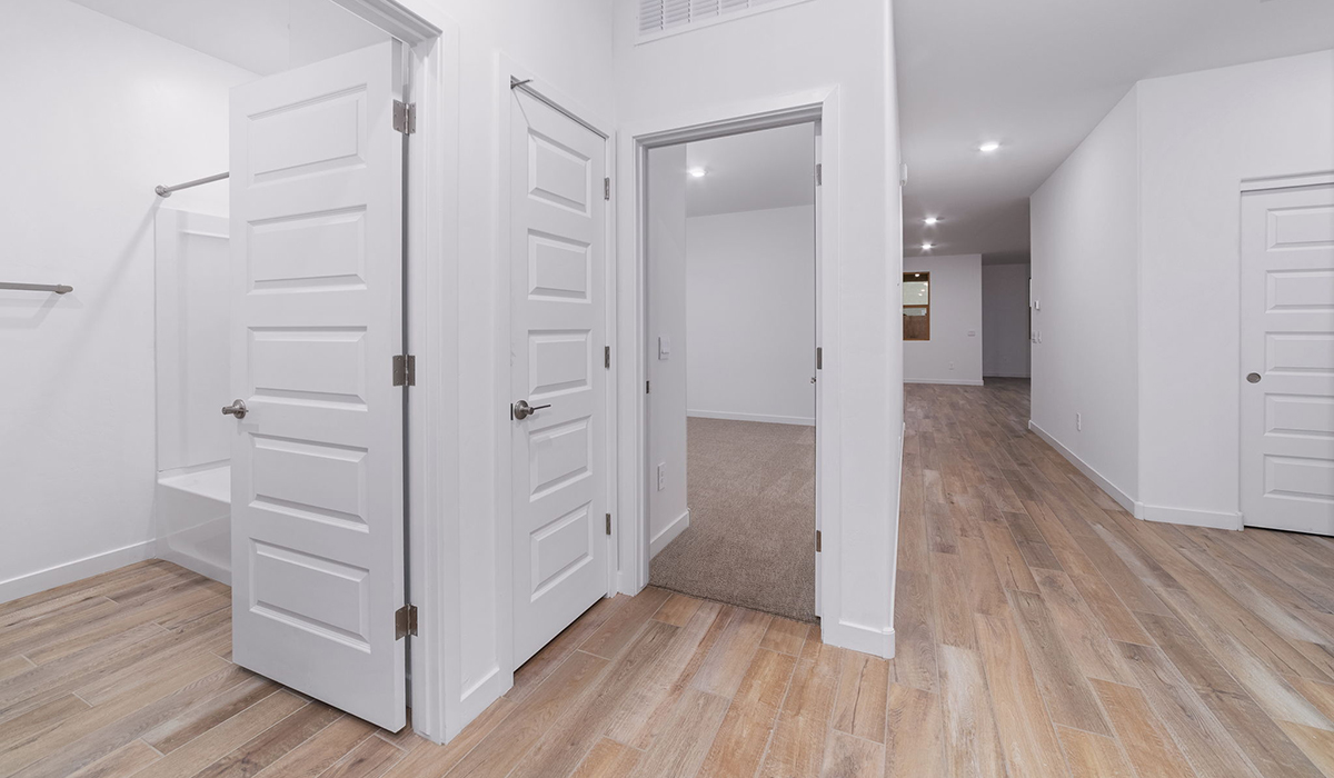 The Garland is a spacious single-story new home situated in the Agave neighborhood at Saguaro Bloom, offering 2,273 square feet of well-planned living. This home features four bedrooms and three full bathrooms making it an ideal choice for families and those needing room to grow.  As you enter through the porch and into the front door, you're greeted by the open concept layout with a seamless flow between the living, dining, and kitchen area. The kitchen features a large central island, quartz countertops, and your choice of flat panel Shaker-style cabinet doors with multiple color options available. A walk-in pantry provides additional storage, making it easy to keep everything organized.  The Garland's four bedrooms are thoughtfully arranged to provide both privacy and convenience. The primary suite is tucked away at the rear of the home, offering a private retreat with walk-in closets off the en-suite bathroom complete with an optional dual sink vanity. The additional bedrooms are strategically placed near the front and center of the home, each with access to a full bathroom, ensuring comfort for all family members or guests.  The large great room serves as the central gathering space, perfect for family activities or entertaining guests. Adjacent to the great room is a covered patio, extending your living space outdoors and offering a perfect spot to enjoy the serene surroundings of Saguaro Bloom.  Practical features like a dedicated utility room and a spacious three-car garage enhance the functionality of this home, while large windows ensure that natural light fills the space, creating a bright and inviting atmosphere.  Located within the vibrant Saguaro Bloom community, residents of The Garland can take advantage of a wide array of amenities, from resort-style pools to extensive walking trails. This home offers a unique opportunity to enjoy both comfort and community in one of Marana’s most sought-after neighborhoods.  *Images shown are for reference only. They depict the Garland floor plan and may not represent the actual home.