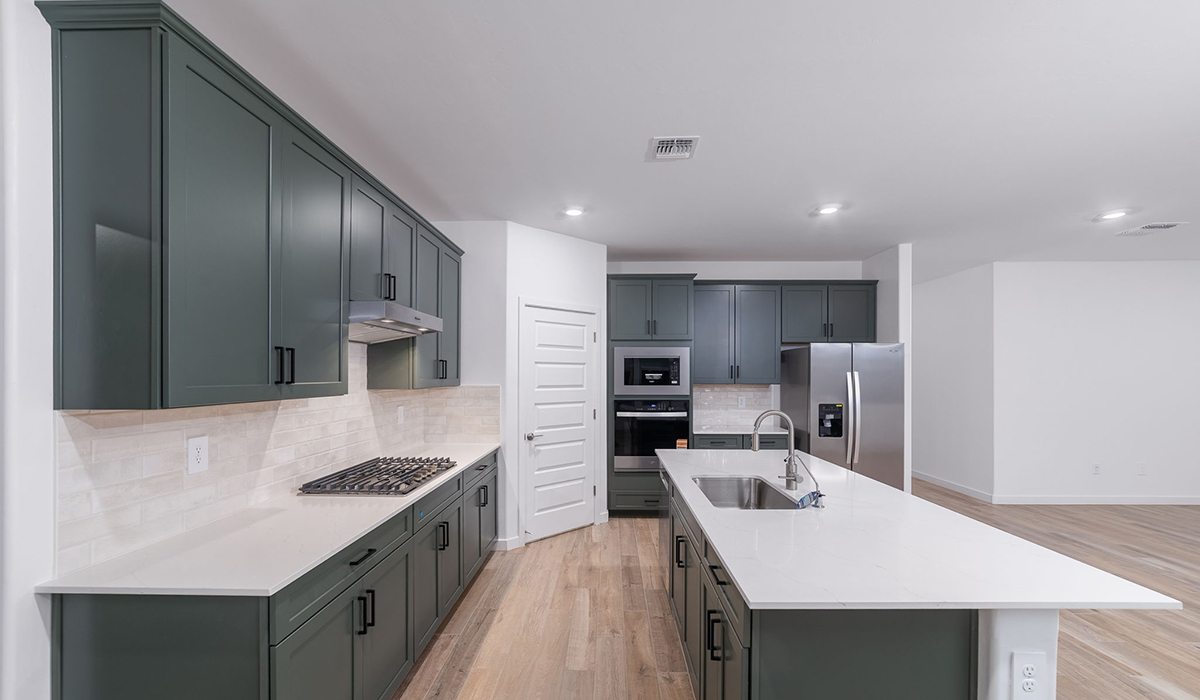 The Garland is a spacious single-story new home situated in the Agave neighborhood at Saguaro Bloom, offering 2,273 square feet of well-planned living. This home features four bedrooms and three full bathrooms making it an ideal choice for families and those needing room to grow.  As you enter through the porch and into the front door, you're greeted by the open concept layout with a seamless flow between the living, dining, and kitchen area. The kitchen features a large central island, quartz countertops, and your choice of flat panel Shaker-style cabinet doors with multiple color options available. A walk-in pantry provides additional storage, making it easy to keep everything organized.  The Garland's four bedrooms are thoughtfully arranged to provide both privacy and convenience. The primary suite is tucked away at the rear of the home, offering a private retreat with walk-in closets off the en-suite bathroom complete with an optional dual sink vanity. The additional bedrooms are strategically placed near the front and center of the home, each with access to a full bathroom, ensuring comfort for all family members or guests.  The large great room serves as the central gathering space, perfect for family activities or entertaining guests. Adjacent to the great room is a covered patio, extending your living space outdoors and offering a perfect spot to enjoy the serene surroundings of Saguaro Bloom.  Practical features like a dedicated utility room and a spacious three-car garage enhance the functionality of this home, while large windows ensure that natural light fills the space, creating a bright and inviting atmosphere.  Located within the vibrant Saguaro Bloom community, residents of The Garland can take advantage of a wide array of amenities, from resort-style pools to extensive walking trails. This home offers a unique opportunity to enjoy both comfort and community in one of Marana’s most sought-after neighborhoods.  *Images shown are for reference only. They depict the Garland floor plan and may not represent the actual home.