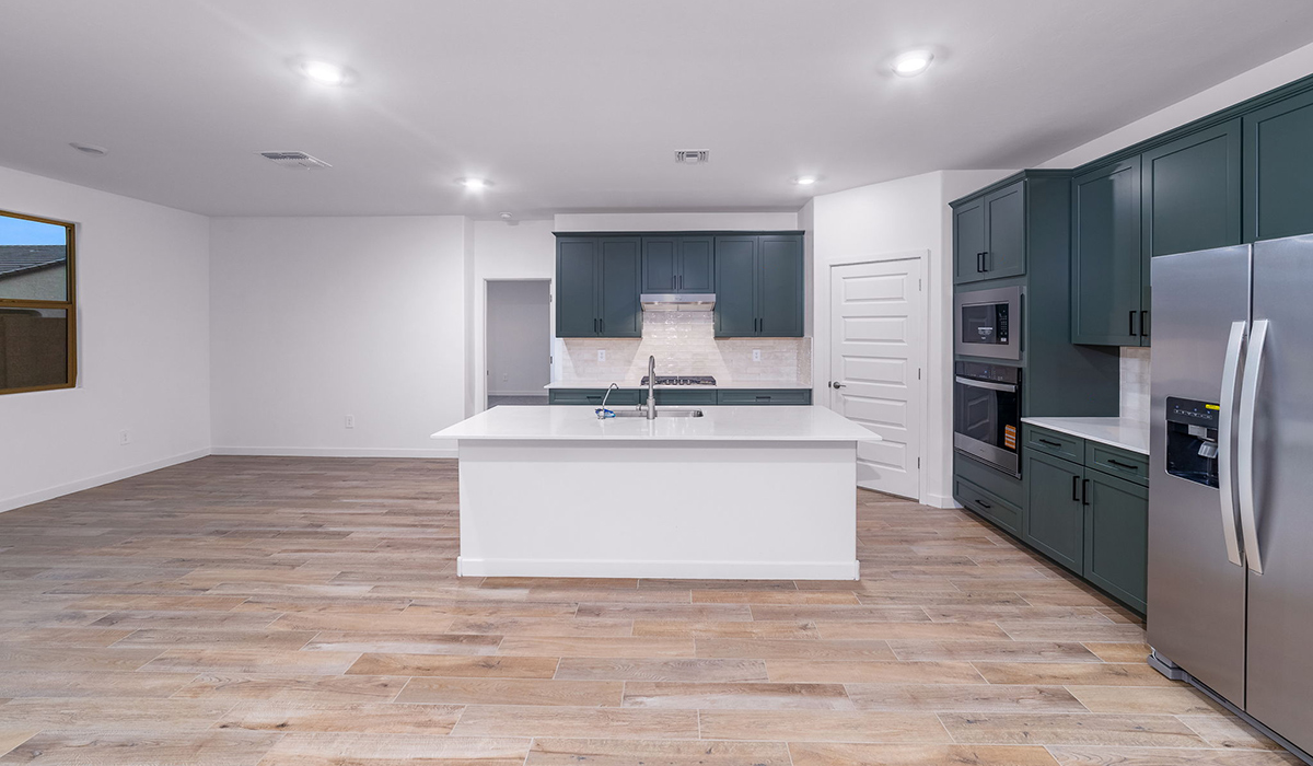 The Garland is a spacious single-story new home situated in the Agave neighborhood at Saguaro Bloom, offering 2,273 square feet of well-planned living. This home features four bedrooms and three full bathrooms making it an ideal choice for families and those needing room to grow.  As you enter through the porch and into the front door, you're greeted by the open concept layout with a seamless flow between the living, dining, and kitchen area. The kitchen features a large central island, quartz countertops, and your choice of flat panel Shaker-style cabinet doors with multiple color options available. A walk-in pantry provides additional storage, making it easy to keep everything organized.  The Garland's four bedrooms are thoughtfully arranged to provide both privacy and convenience. The primary suite is tucked away at the rear of the home, offering a private retreat with walk-in closets off the en-suite bathroom complete with an optional dual sink vanity. The additional bedrooms are strategically placed near the front and center of the home, each with access to a full bathroom, ensuring comfort for all family members or guests.  The large great room serves as the central gathering space, perfect for family activities or entertaining guests. Adjacent to the great room is a covered patio, extending your living space outdoors and offering a perfect spot to enjoy the serene surroundings of Saguaro Bloom.  Practical features like a dedicated utility room and a spacious three-car garage enhance the functionality of this home, while large windows ensure that natural light fills the space, creating a bright and inviting atmosphere.  Located within the vibrant Saguaro Bloom community, residents of The Garland can take advantage of a wide array of amenities, from resort-style pools to extensive walking trails. This home offers a unique opportunity to enjoy both comfort and community in one of Marana’s most sought-after neighborhoods.  *Images shown are for reference only. They depict the Garland floor plan and may not represent the actual home.