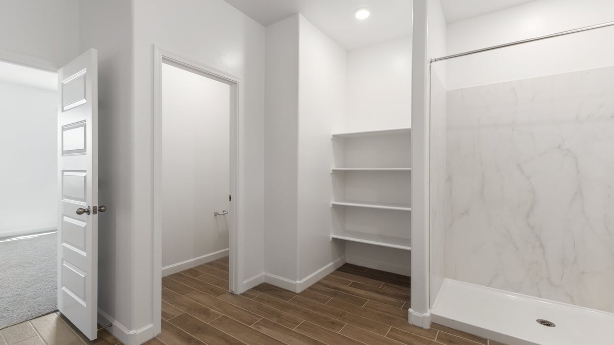 The Garland is a spacious single-story new home situated in the Agave neighborhood at Saguaro Bloom, offering 2,273 square feet of well-planned living. This home features four bedrooms and three full bathrooms making it an ideal choice for families and those needing room to grow.  As you enter through the porch and into the front door, you're greeted by the open concept layout with a seamless flow between the living, dining, and kitchen area. The kitchen features a large central island, quartz countertops, and your choice of flat panel Shaker-style cabinet doors with multiple color options available. A walk-in pantry provides additional storage, making it easy to keep everything organized.  The Garland's four bedrooms are thoughtfully arranged to provide both privacy and convenience. The primary suite is tucked away at the rear of the home, offering a private retreat with walk-in closets off the en-suite bathroom complete with an optional dual sink vanity. The additional bedrooms are strategically placed near the front and center of the home, each with access to a full bathroom, ensuring comfort for all family members or guests.  The large great room serves as the central gathering space, perfect for family activities or entertaining guests. Adjacent to the great room is a covered patio, extending your living space outdoors and offering a perfect spot to enjoy the serene surroundings of Saguaro Bloom.  Practical features like a dedicated utility room and a spacious three-car garage enhance the functionality of this home, while large windows ensure that natural light fills the space, creating a bright and inviting atmosphere.  Located within the vibrant Saguaro Bloom community, residents of The Garland can take advantage of a wide array of amenities, from resort-style pools to extensive walking trails. This home offers a unique opportunity to enjoy both comfort and community in one of Marana’s most sought-after neighborhoods.  *Images shown are for reference only. They depict a Garland home and may not represent the actual home or design package.