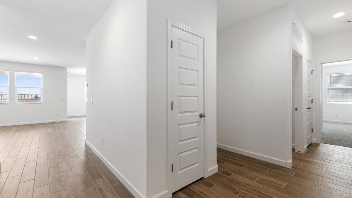 The Garland is a spacious single-story new home situated in the Agave neighborhood at Saguaro Bloom, offering 2,273 square feet of well-planned living. This home features four bedrooms and three full bathrooms making it an ideal choice for families and those needing room to grow.  As you enter through the porch and into the front door, you're greeted by the open concept layout with a seamless flow between the living, dining, and kitchen area. The kitchen features a large central island, quartz countertops, and your choice of flat panel Shaker-style cabinet doors with multiple color options available. A walk-in pantry provides additional storage, making it easy to keep everything organized.  The Garland's four bedrooms are thoughtfully arranged to provide both privacy and convenience. The primary suite is tucked away at the rear of the home, offering a private retreat with walk-in closets off the en-suite bathroom complete with an optional dual sink vanity. The additional bedrooms are strategically placed near the front and center of the home, each with access to a full bathroom, ensuring comfort for all family members or guests.  The large great room serves as the central gathering space, perfect for family activities or entertaining guests. Adjacent to the great room is a covered patio, extending your living space outdoors and offering a perfect spot to enjoy the serene surroundings of Saguaro Bloom.  Practical features like a dedicated utility room and a spacious three-car garage enhance the functionality of this home, while large windows ensure that natural light fills the space, creating a bright and inviting atmosphere.  Located within the vibrant Saguaro Bloom community, residents of The Garland can take advantage of a wide array of amenities, from resort-style pools to extensive walking trails. This home offers a unique opportunity to enjoy both comfort and community in one of Marana’s most sought-after neighborhoods.