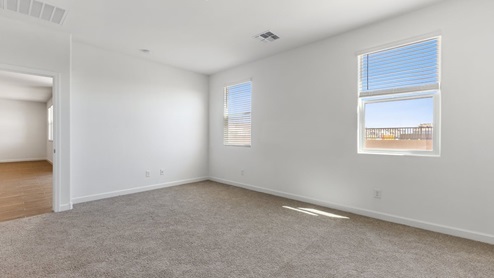 The Garland floor plan is a spacious single-story new home situated in the Agave neighborhood at Saguaro Bloom, offering 2,273 square feet of well-planned living space that perfectly suits a variety of lifestyles. This home features four bedrooms and three full bathrooms making it an ideal choice for families and those needing room to grow. As you step into the front porch and through the front door, you're greeted by the open concept layout with a seamless flow between the living, dining, and kitchen area, ensuring that every part of the home feels connected. The kitchen, equipped with a central island, quartz countertops, and your choice of flat panel Shaker-style cabinet doors with multiple color options available. A walk-in pantry provides additional storage, making it easy to keep everything organized. The Garland's four bedrooms are thoughtfully arranged to provide both privacy and convenience. The primary suite is tucked away at the rear of the home, offering a private retreat with walk-in closets off the en-suite bathroom complete with an optional dual sink vanity. The additional bedrooms are strategically placed near the front and center of the home, each with access to a full bathroom, ensuring comfort for all family members or guests. The large great room serves as the central gathering space, perfect for family activities or entertaining guests. Adjacent to the great room is a covered patio, extending your living space outdoors and offering a perfect spot to enjoy the serene surroundings of Saguaro Bloom. Practical features like a dedicated utility room and a spacious three-car garage enhance the functionality of this home, while large windows ensure that natural light fills the space, creating a bright and inviting atmosphere. Located within the vibrant Saguaro Bloom community, residents of The Garland can take advantage of a wide array of amenities, from resort-style pools to extensive walking trails. This home offers a unique opportunity to enjoy both comfort and community in one of Marana’s most sought-after neighborhoods.
