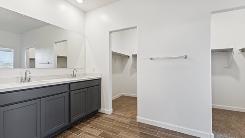 The Garland floor plan is a spacious single-story new home situated in the Agave neighborhood at Saguaro Bloom, offering 2,273 square feet of well-planned living space that perfectly suits a variety of lifestyles. This home features four bedrooms and three full bathrooms making it an ideal choice for families and those needing room to grow. As you step into the front porch and through the front door, you're greeted by the open concept layout with a seamless flow between the living, dining, and kitchen area, ensuring that every part of the home feels connected. The kitchen, equipped with a central island, quartz countertops, and your choice of flat panel Shaker-style cabinet doors with multiple color options available. A walk-in pantry provides additional storage, making it easy to keep everything organized. The Garland's four bedrooms are thoughtfully arranged to provide both privacy and convenience. The primary suite is tucked away at the rear of the home, offering a private retreat with walk-in closets off the en-suite bathroom complete with an optional dual sink vanity. The additional bedrooms are strategically placed near the front and center of the home, each with access to a full bathroom, ensuring comfort for all family members or guests. The large great room serves as the central gathering space, perfect for family activities or entertaining guests. Adjacent to the great room is a covered patio, extending your living space outdoors and offering a perfect spot to enjoy the serene surroundings of Saguaro Bloom. Practical features like a dedicated utility room and a spacious three-car garage enhance the functionality of this home, while large windows ensure that natural light fills the space, creating a bright and inviting atmosphere. Located within the vibrant Saguaro Bloom community, residents of The Garland can take advantage of a wide array of amenities, from resort-style pools to extensive walking trails. This home offers a unique opportunity to enjoy both comfort and community in one of Marana’s most sought-after neighborhoods.